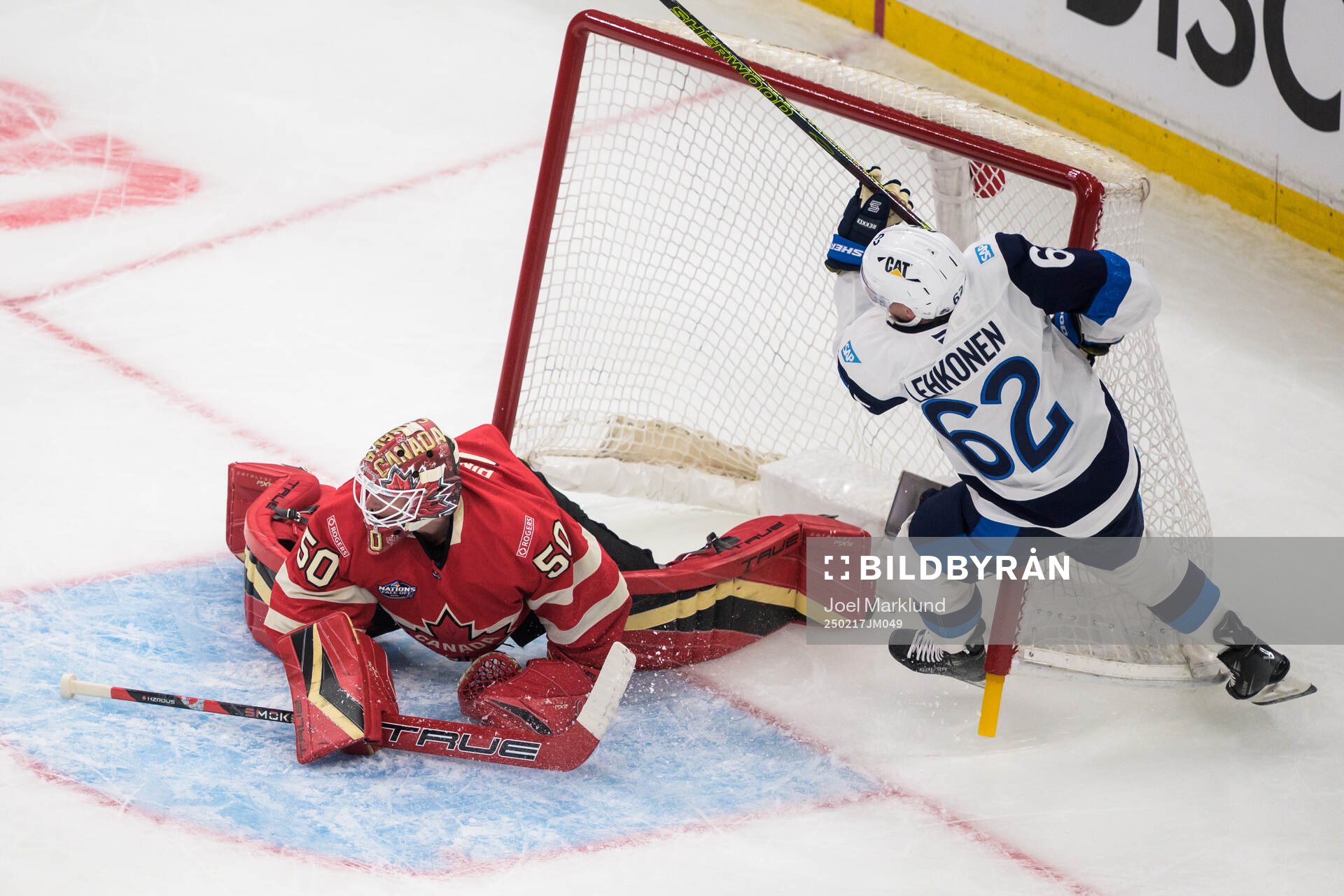 Goaltender Jordan Binnington of Canada and Artturi Lehkonen