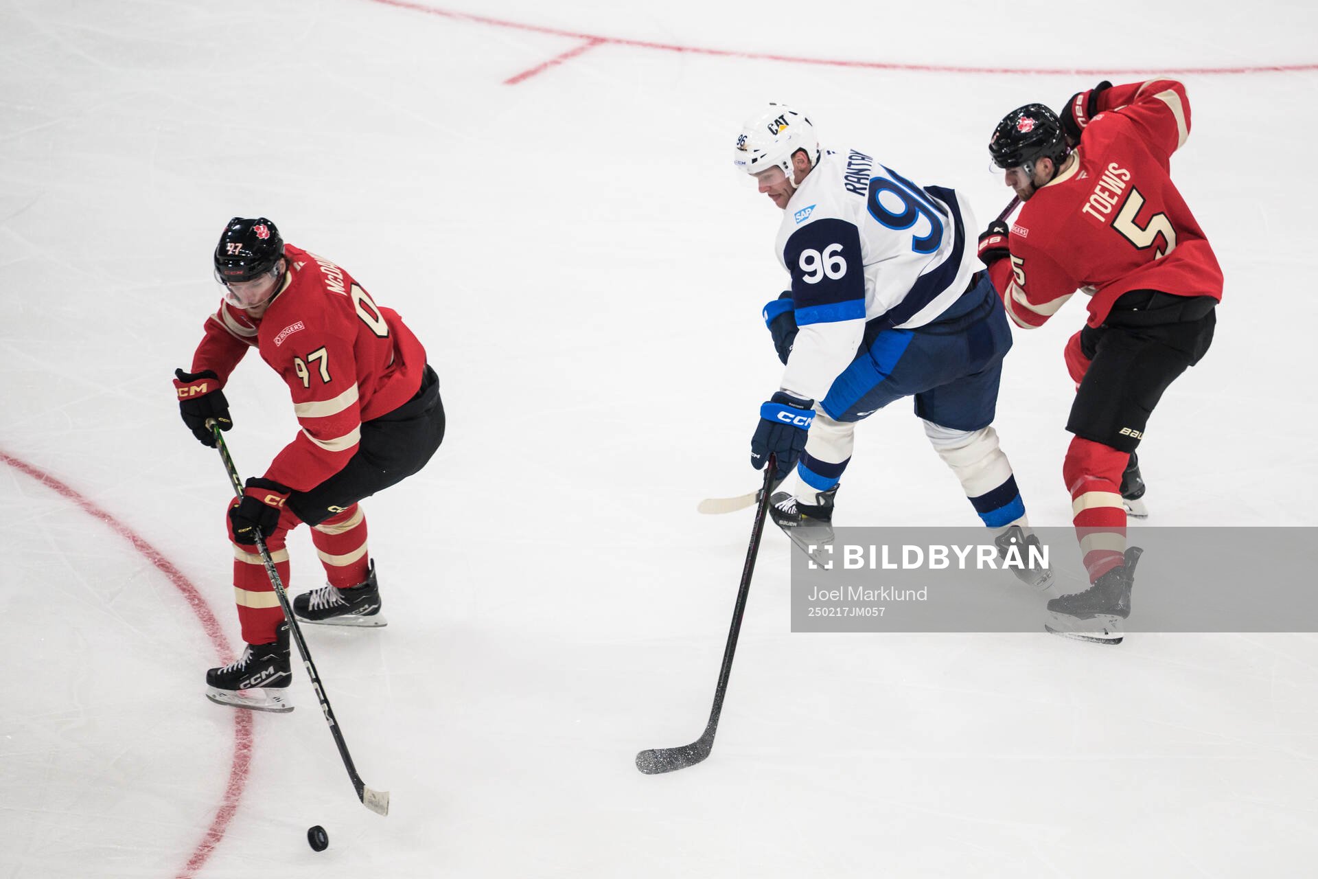 Connor McDavid and Devon Toews of Canada in action against