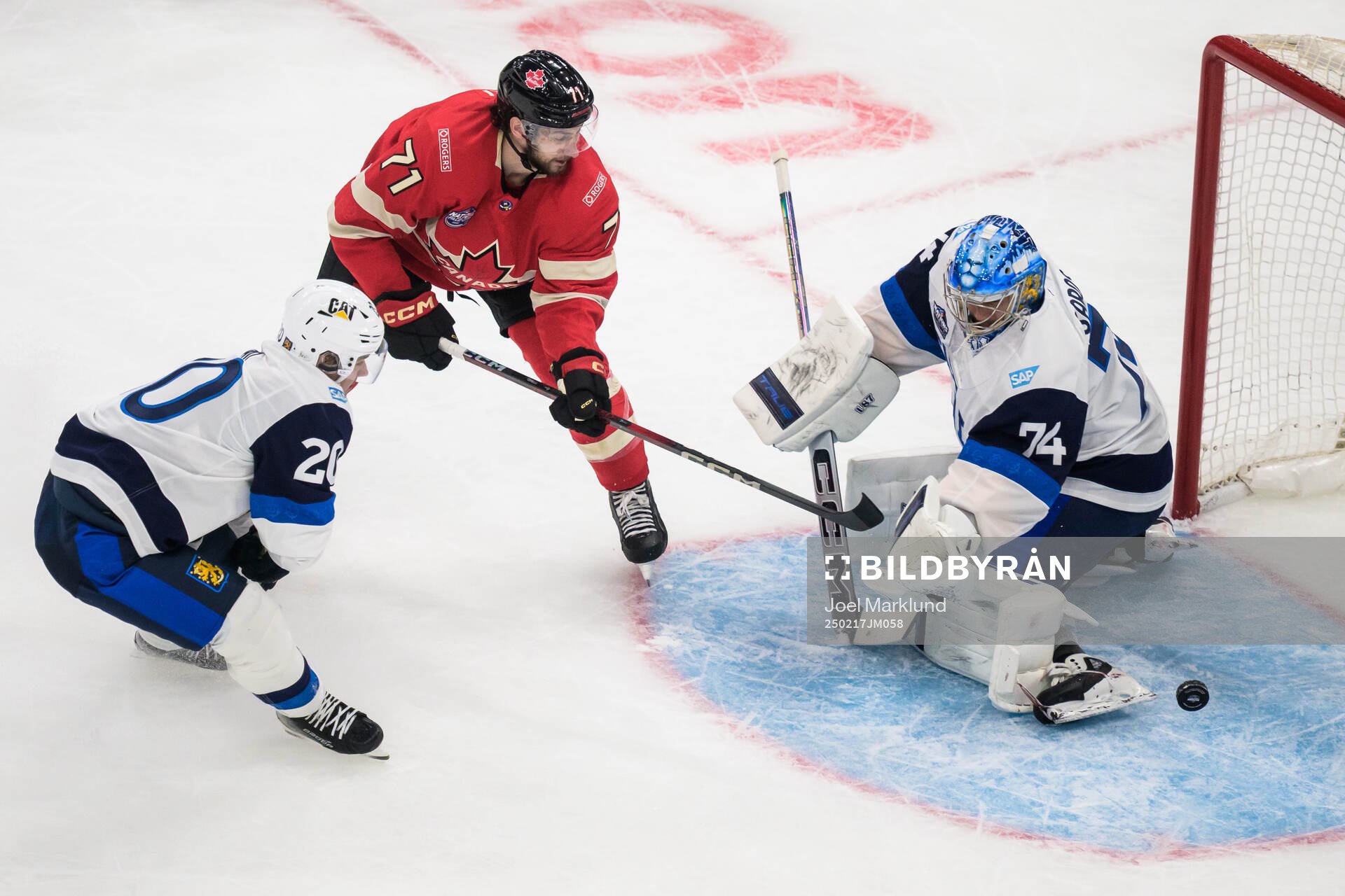 Sebastian Aho and goaltender Juuse Saros of Finland are