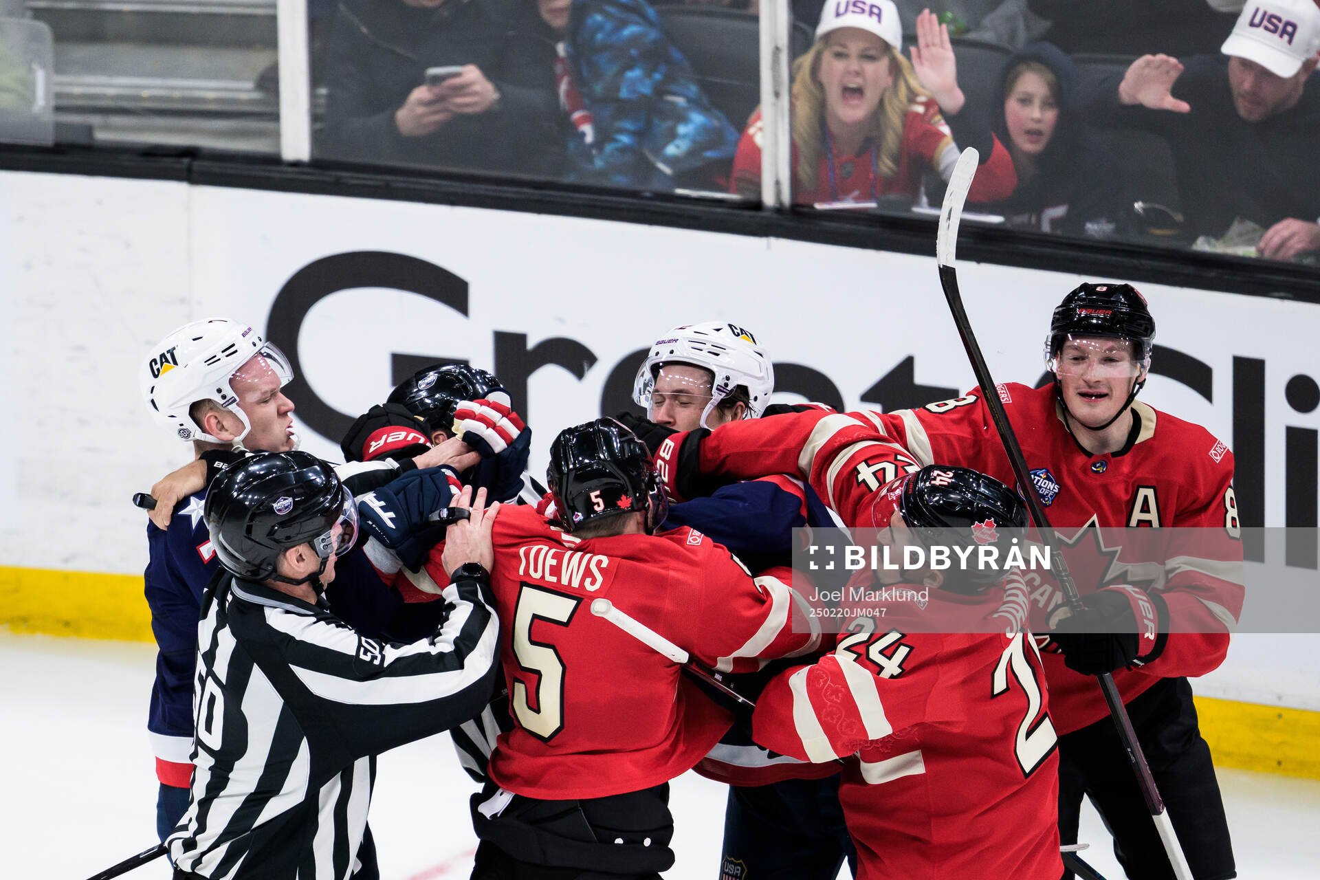 Brady Tkachuk and Matt Boldy of USA against Devon Toews,
