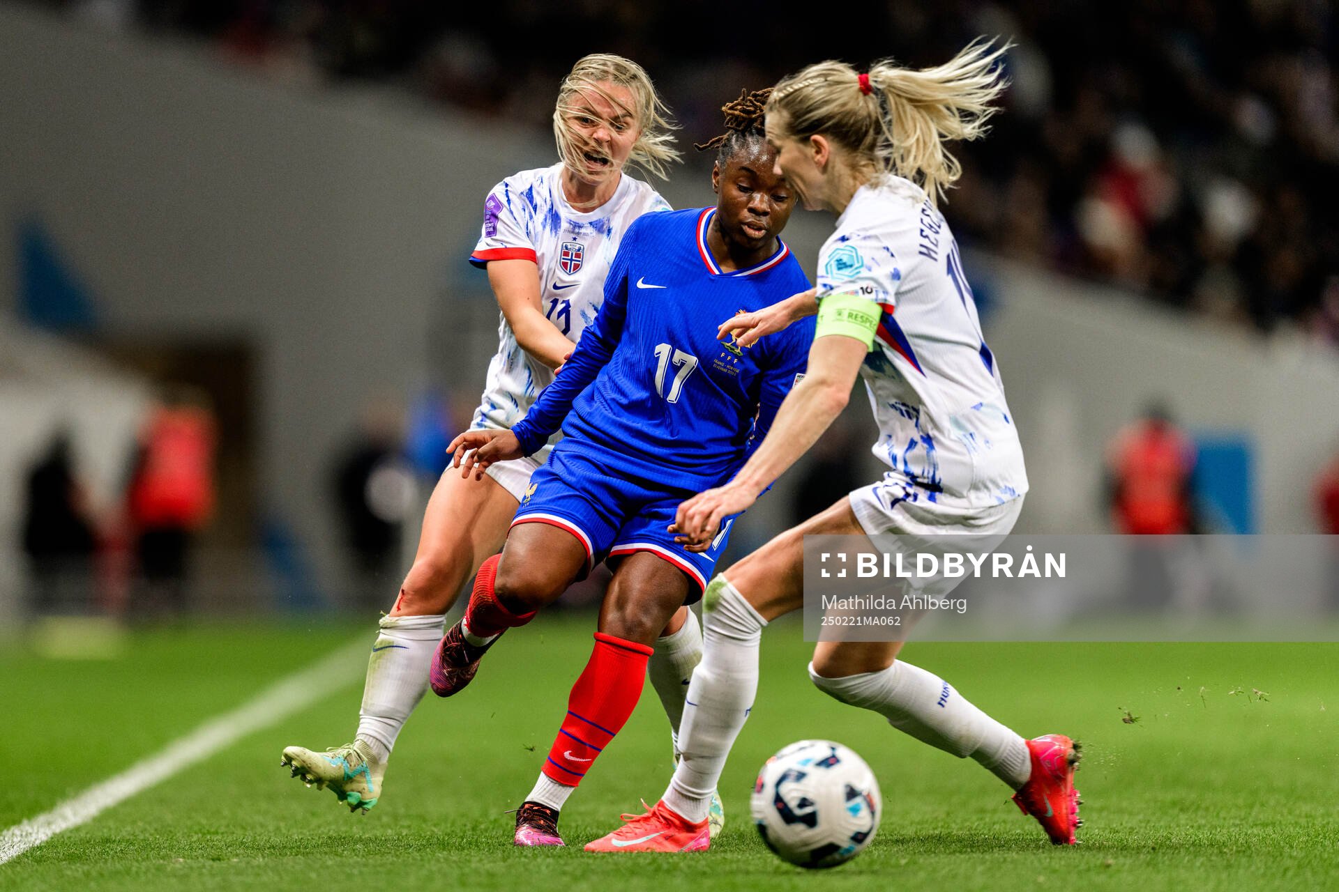 Emilie Woldvik and Ada Hegerberg of Norway against Sandy Baltimore of France during the Women's Nations League football match between France and Norway on February 21, 2025 in Toulouse.