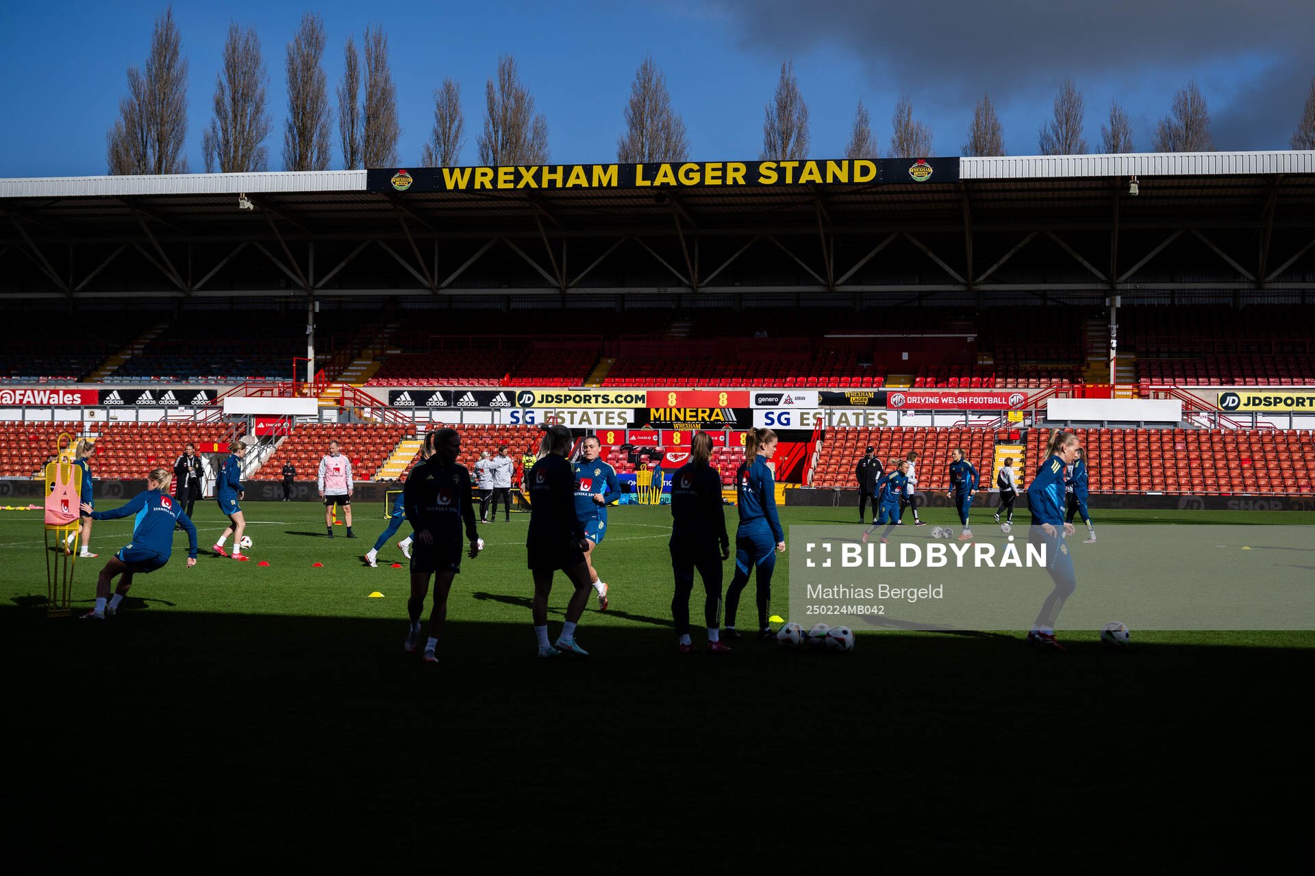 A stand at Racecourse Ground with players of the Swedish