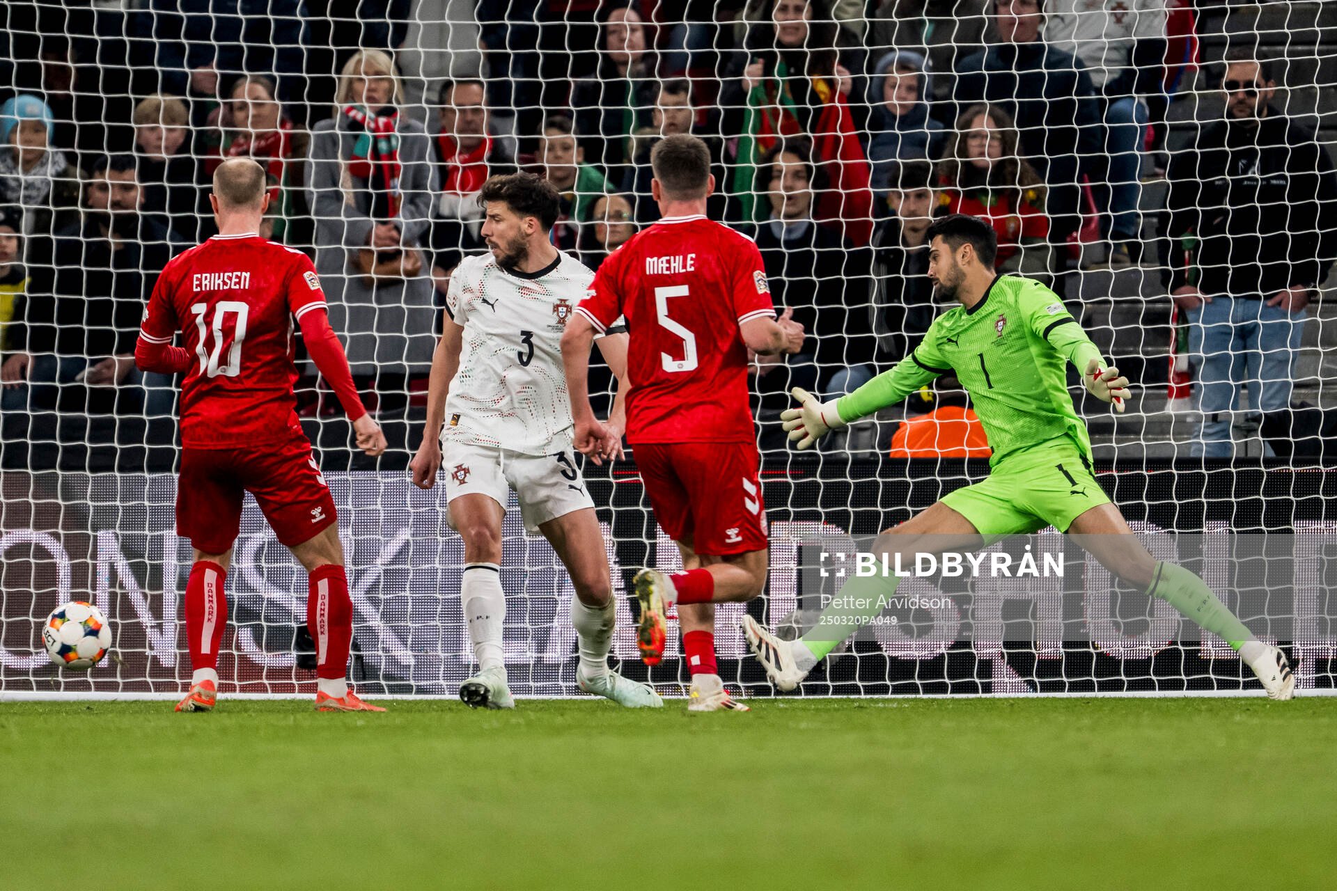 Christian Eriksen of Denmark and goalkeeper Diogo Costa of
