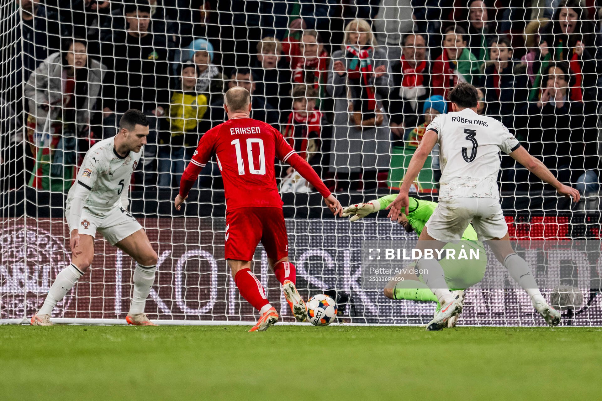 Christian Eriksen of Denmark and goalkeeper Diogo Costa of