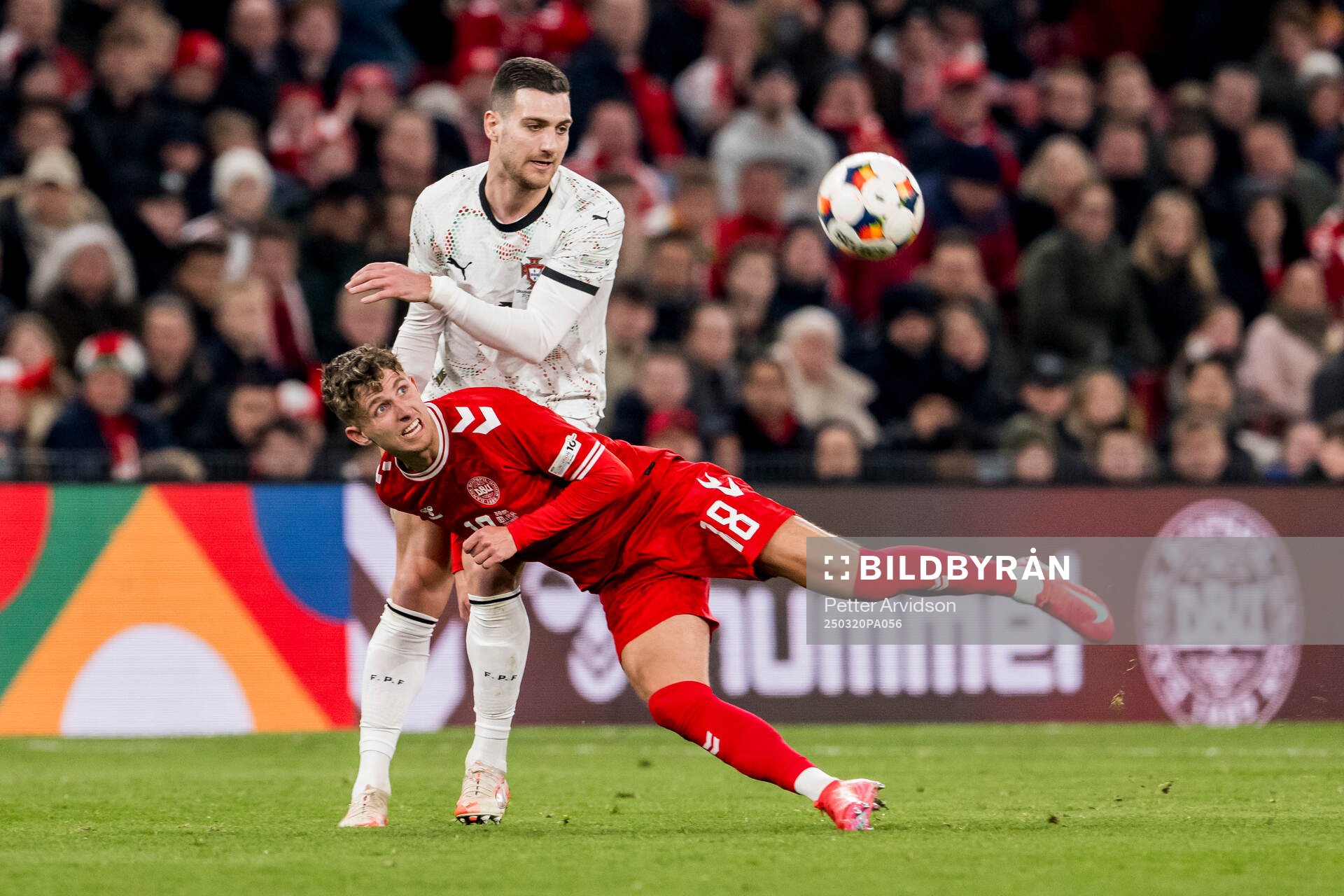 Diogo Dalot of Portugal and Jesper Lindstrøm of Denmark