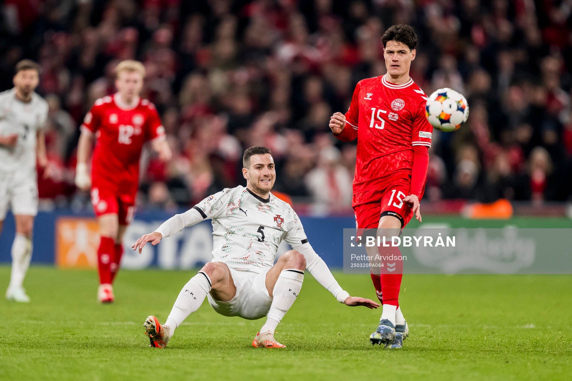 Diogo Dalot of Portugal and Christian Nørgaard of Denmark