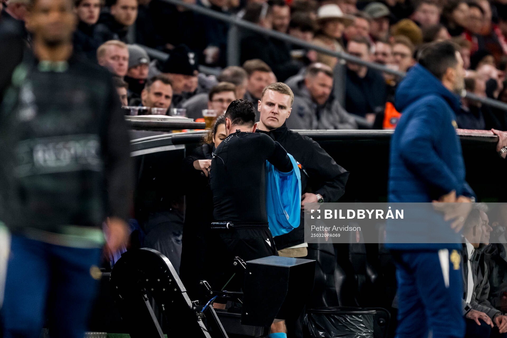 Referee Irfan Peljto receives a new headset during the Nations League football match between Denmark and Portugal on March 20, 2025 in Copenhagen.