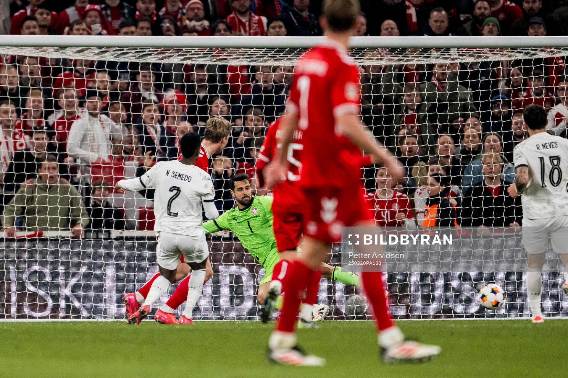 Rasmus Højlund of Denmark scores 1-0 behind goalkeeper