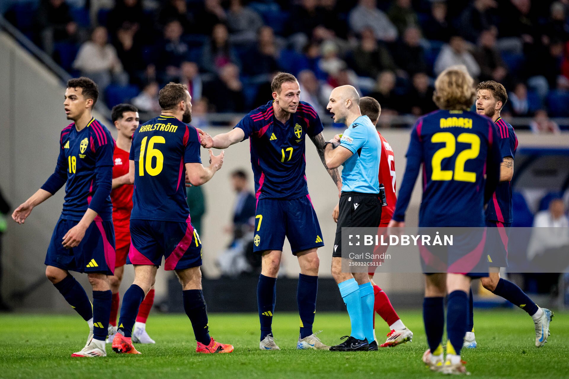 Jesper Karlström and Gustaf Nilsson of Sweden with referee