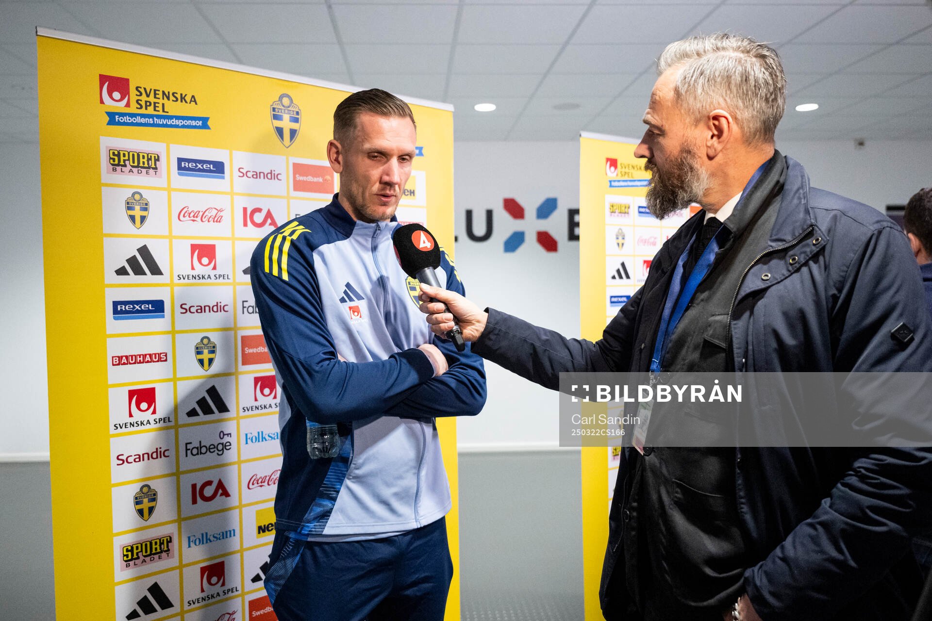 Goalkeeper Robin Olsen of Sweden and sport reporter Olof