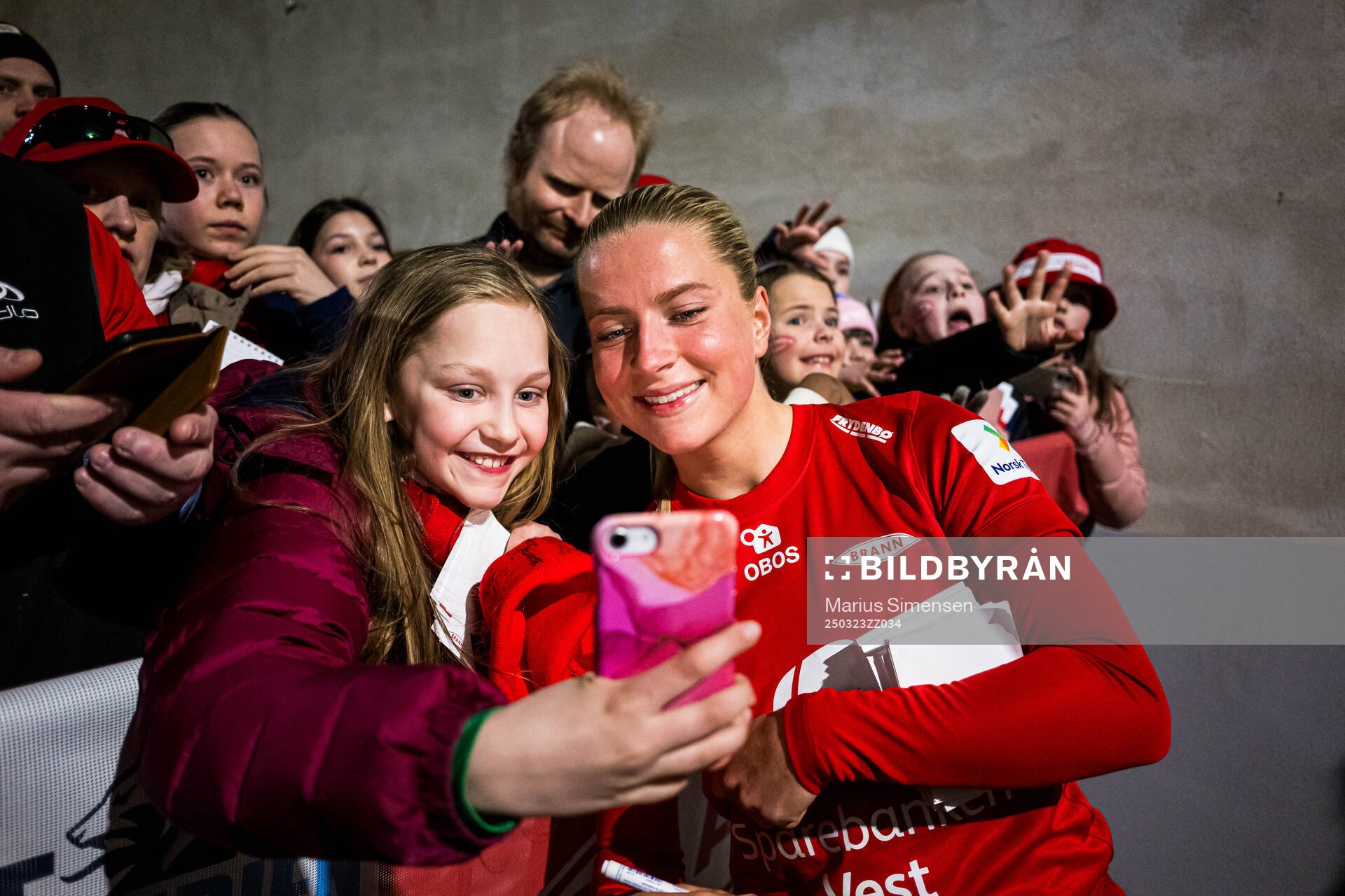Monica Nedgård Isaksen of Brann taking a selfie with a fan after the Toppserien football match between Brann and Rosenborg on March 23, 2025 in Bergen.