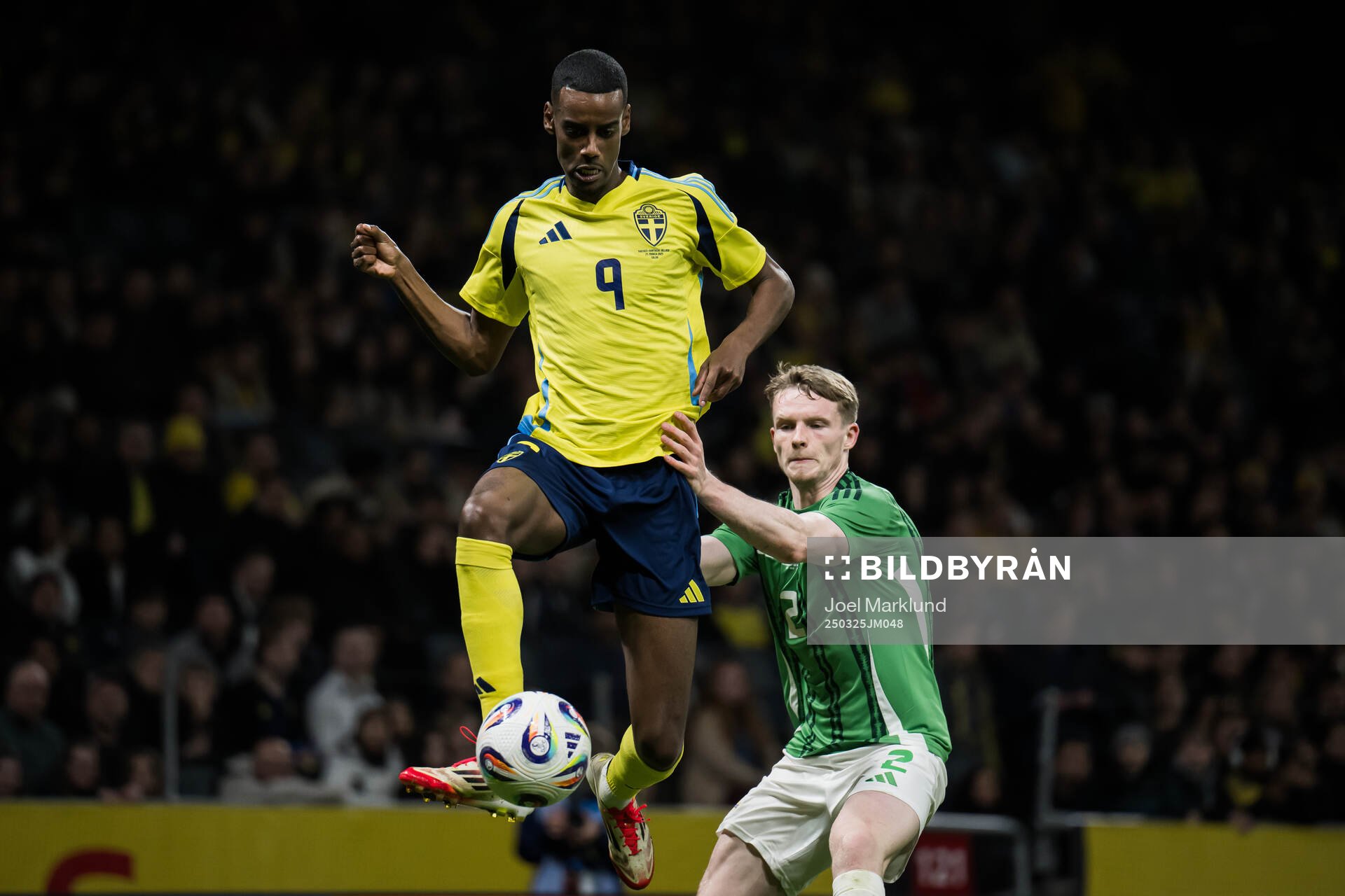 Alexander Isak of Sweden and Terry Devlin of Northern Ireland during the international friendly football match between Sweden and Northern Ireland on March 25, 2025 in Stockholm.