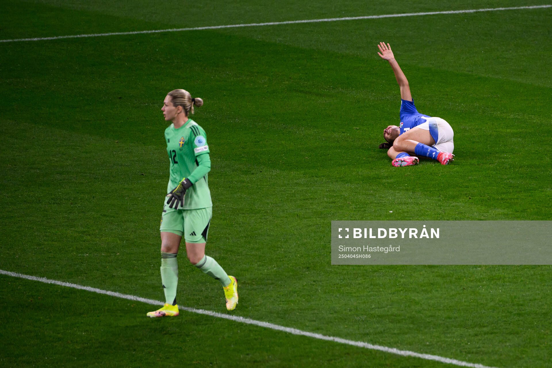 Chiara Beccari of Italy in pain behind goalkeeper Jennifer
