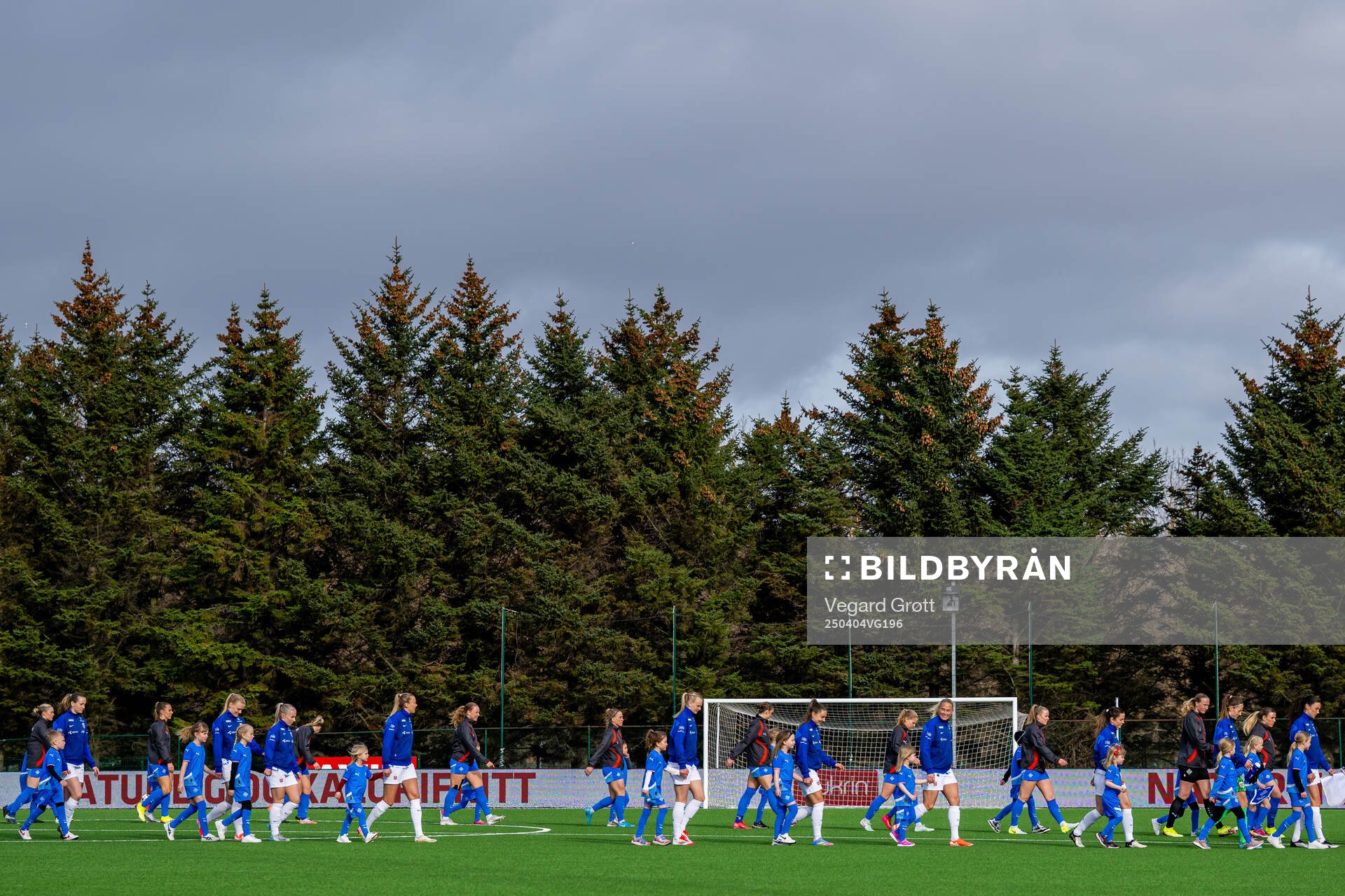 Players of Iceland and Norway enter the pitch
