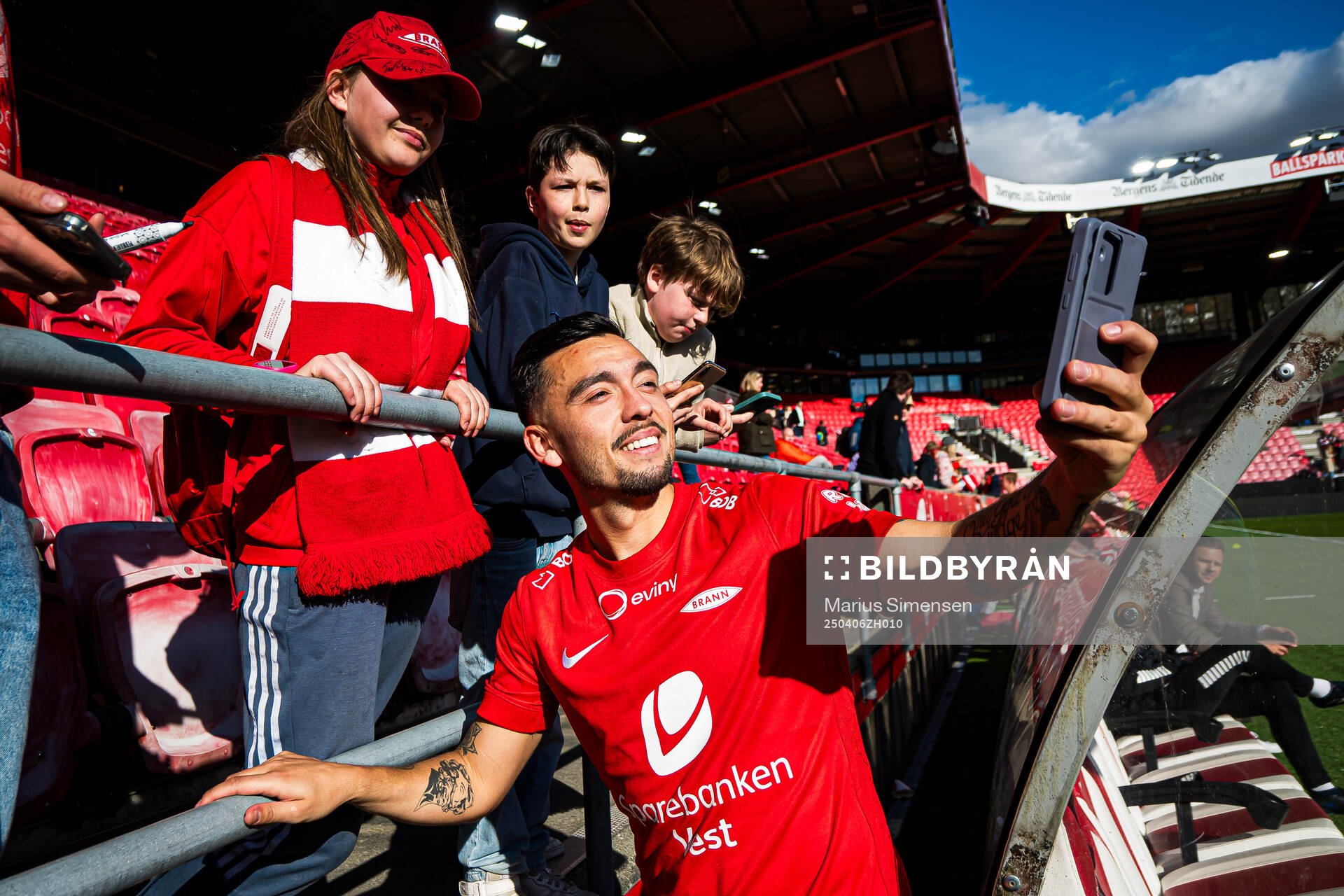 Niklas Castro of Brann taking a selfie with a fan