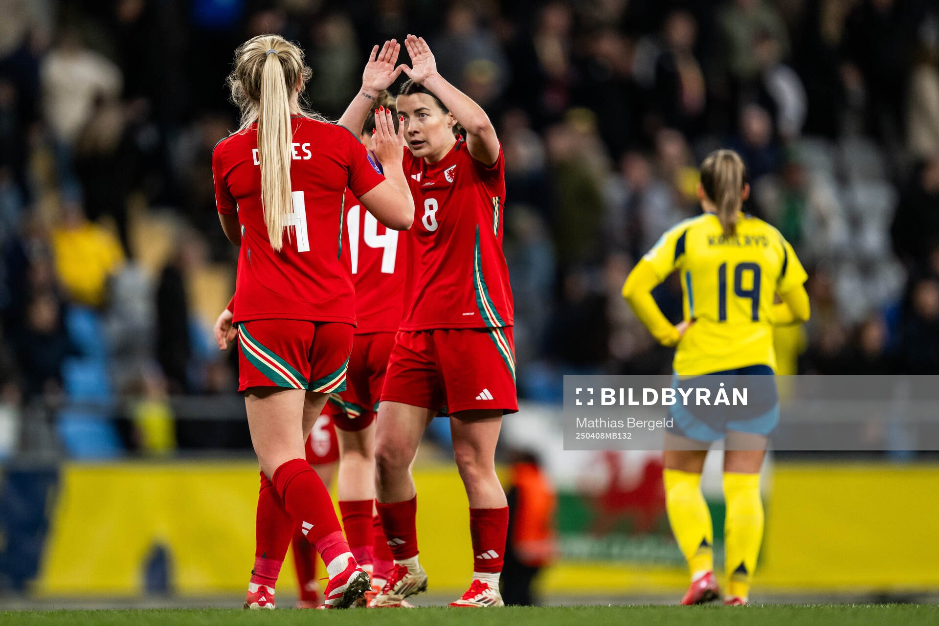 Mayzee Davies and Angharad James of Wales celebrate