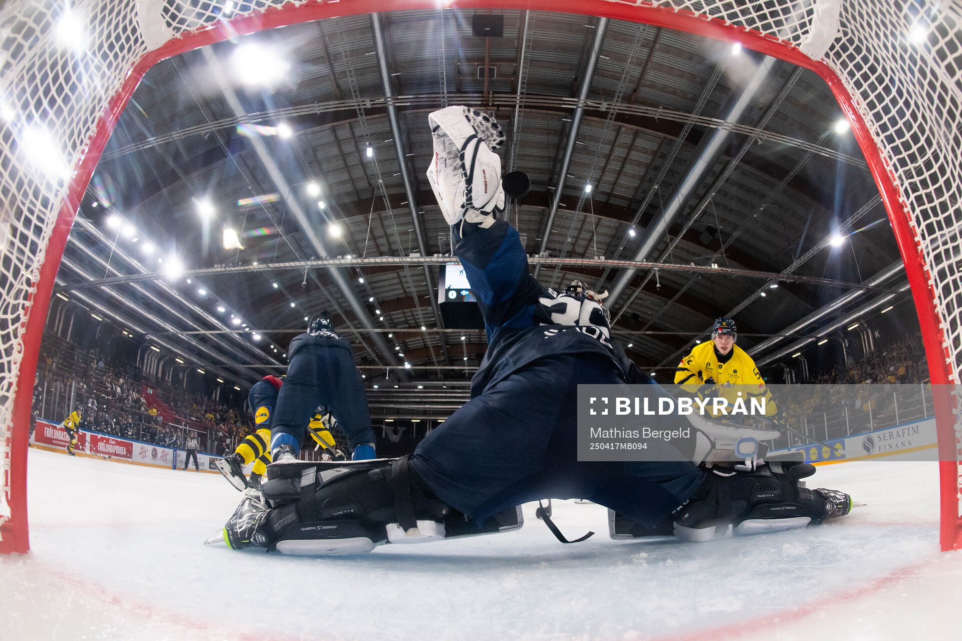 Felix Nilsson of Sweden scores 1-1 behind goaltender Oskari