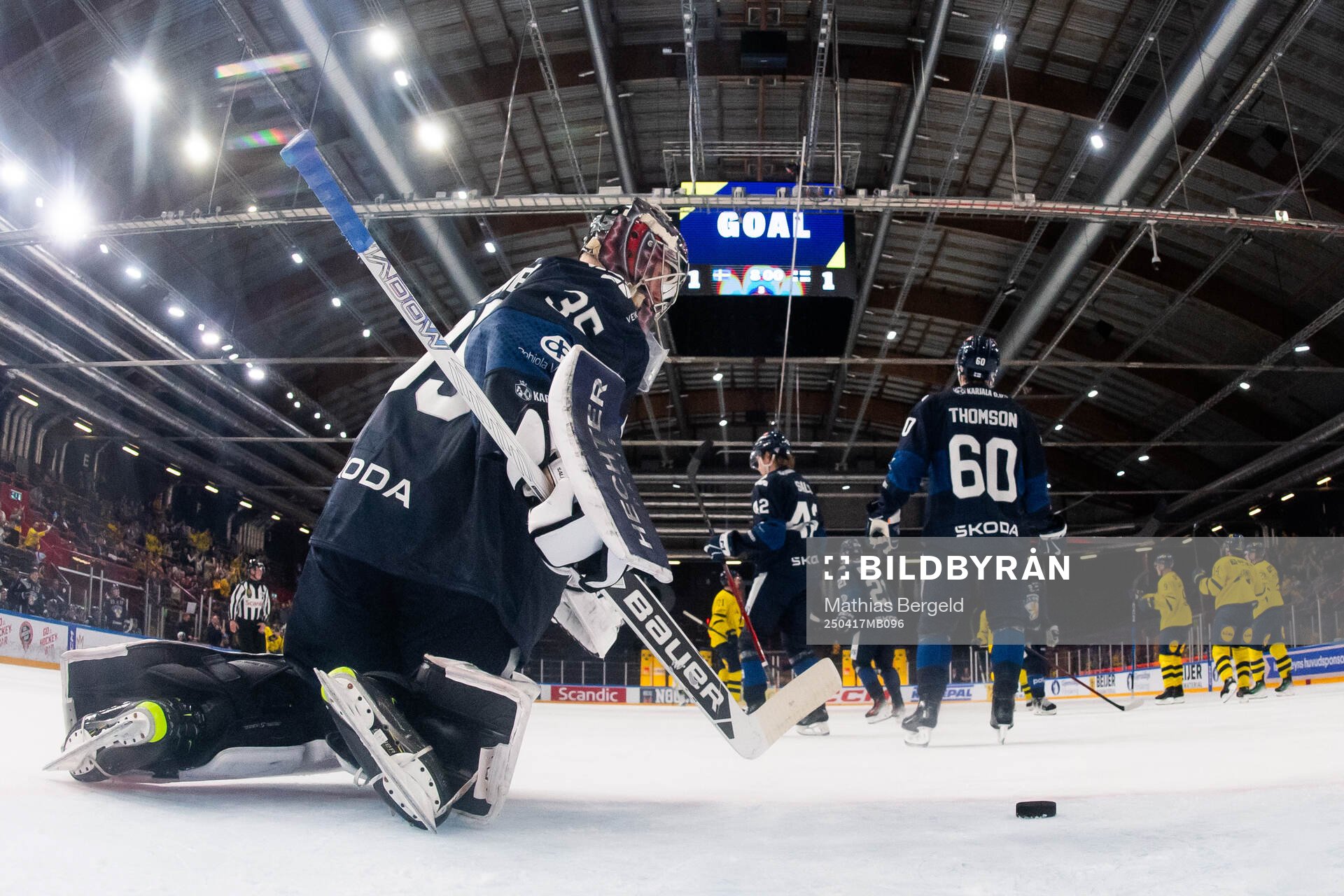 Goaltender Oskari Salminen of Finland looks dejected