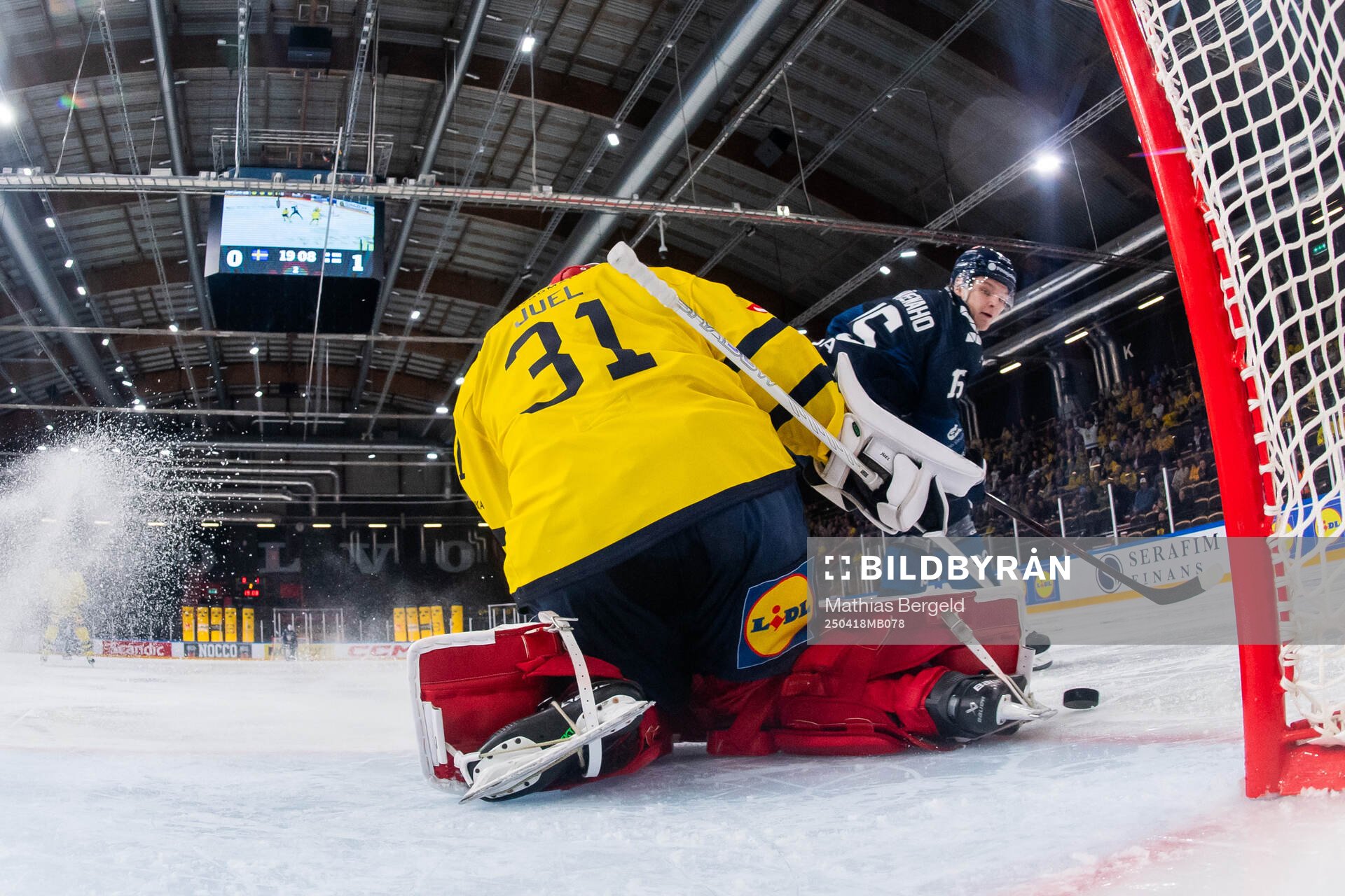 Lenni Härmeenaho of Finland and goaltender Tim Juel of