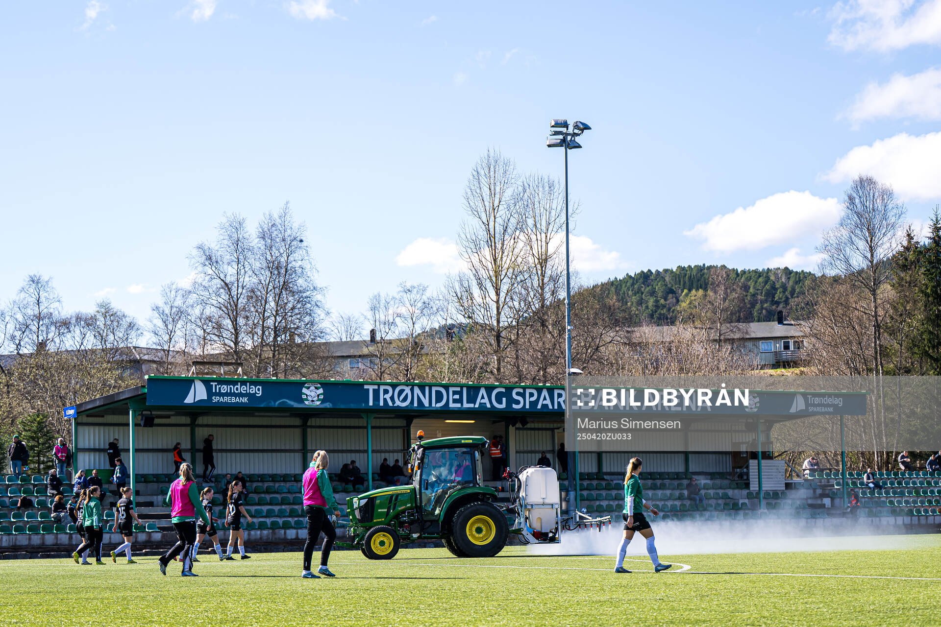 A tractor waters the pitch at half-time break