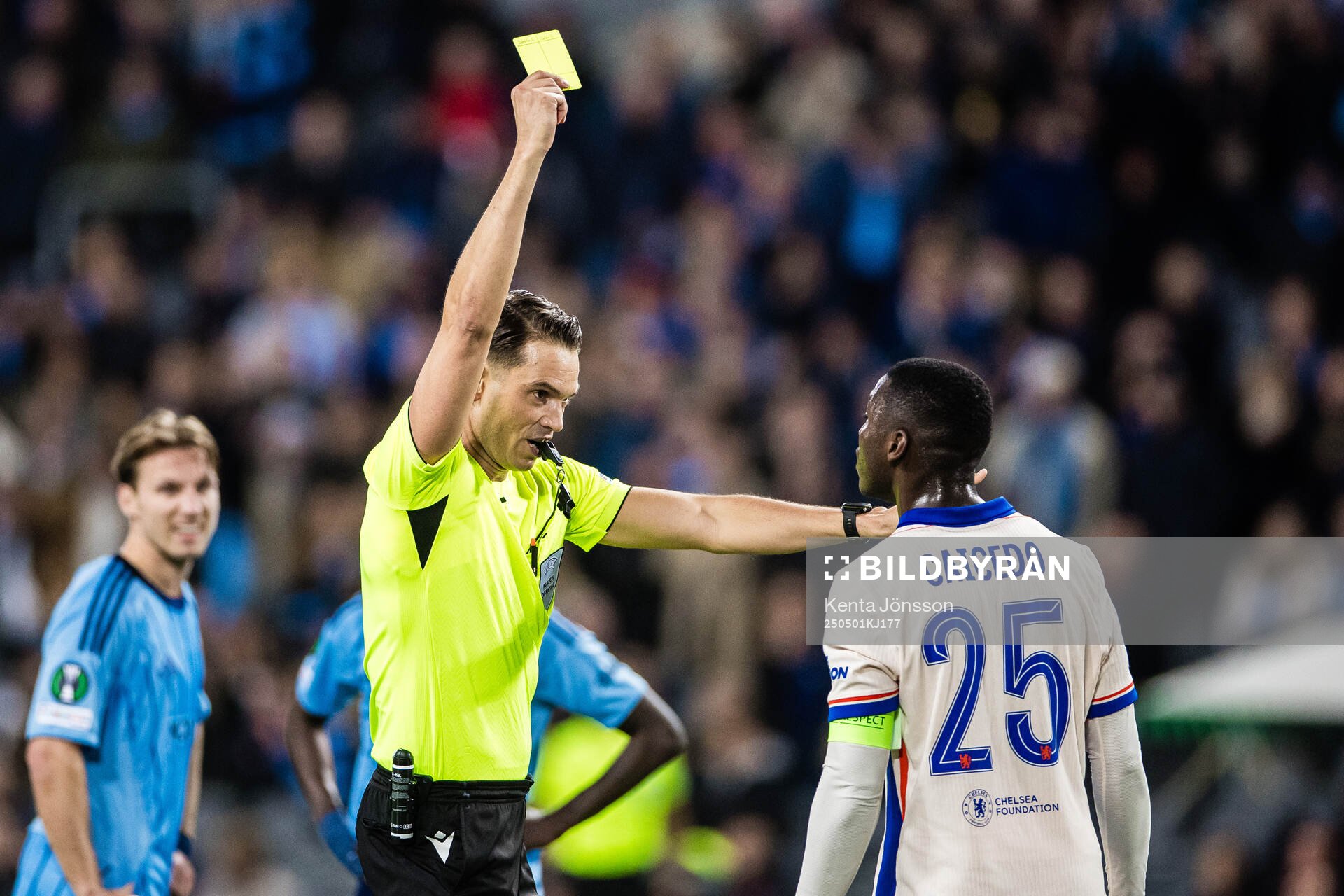 Referee Sandro Schärer shows a yellow card to  Moises