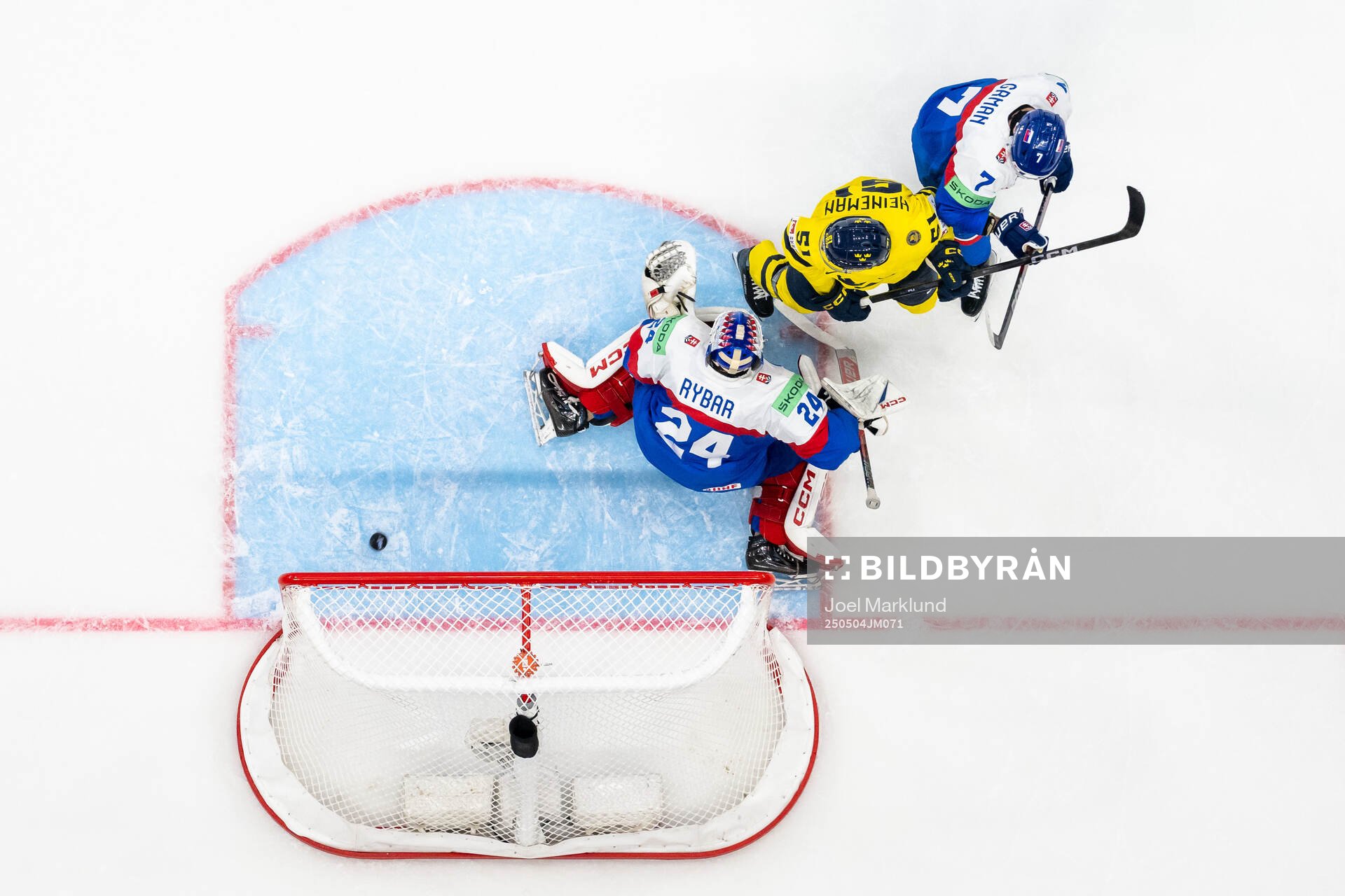 Emil Heineman of Sweden with goaltender Patrik Rybar and Mario Grman of Slovakia as Elias Lindholm of Sweden (not pictured) score 4-0 under fotbollsmatchen i Allsvenskan mellan Djurgården och AIK den 4 maj 2025 i Stockholm.