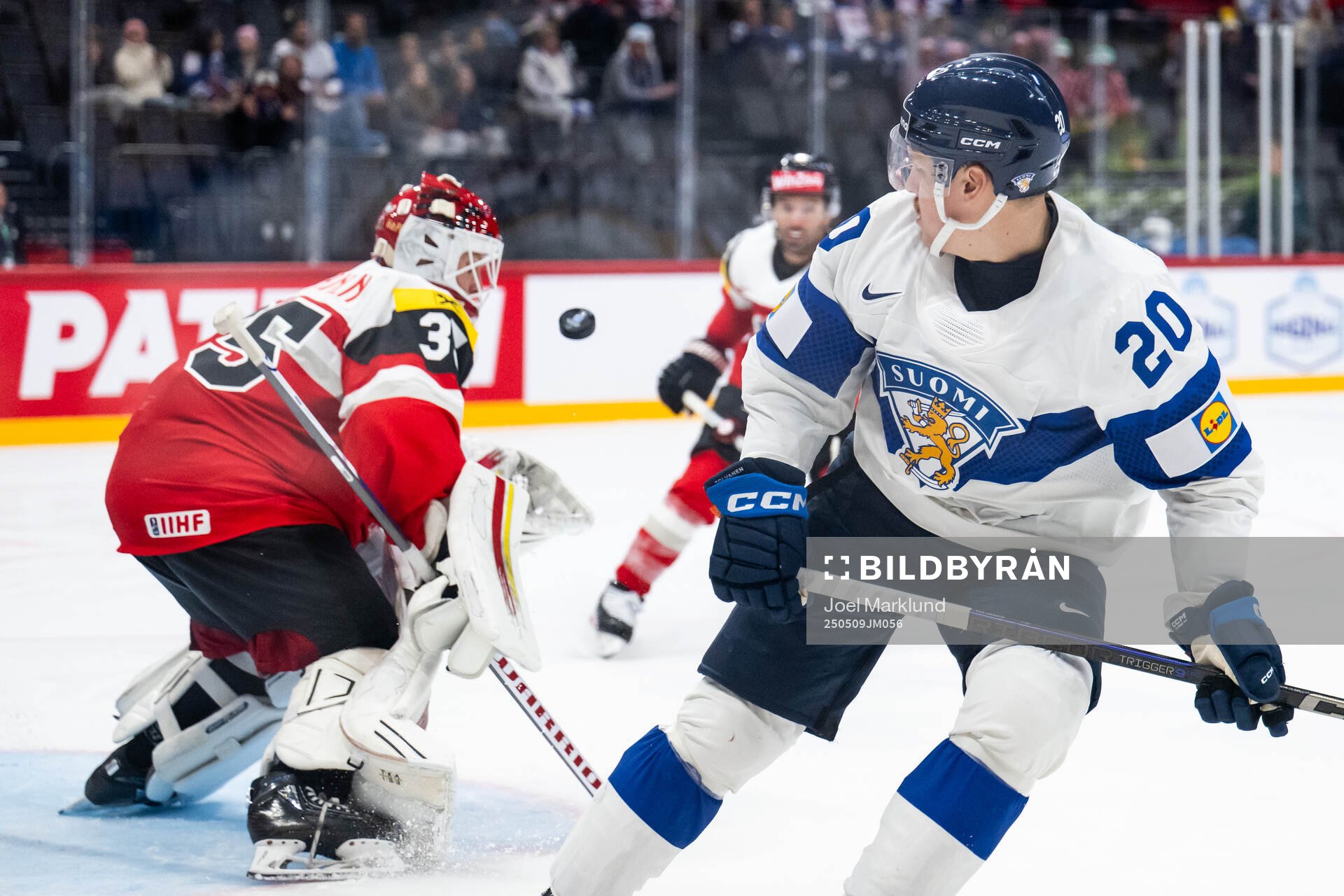 Goaltender Atte Tolvanen of Austria saves a shot from Eeli