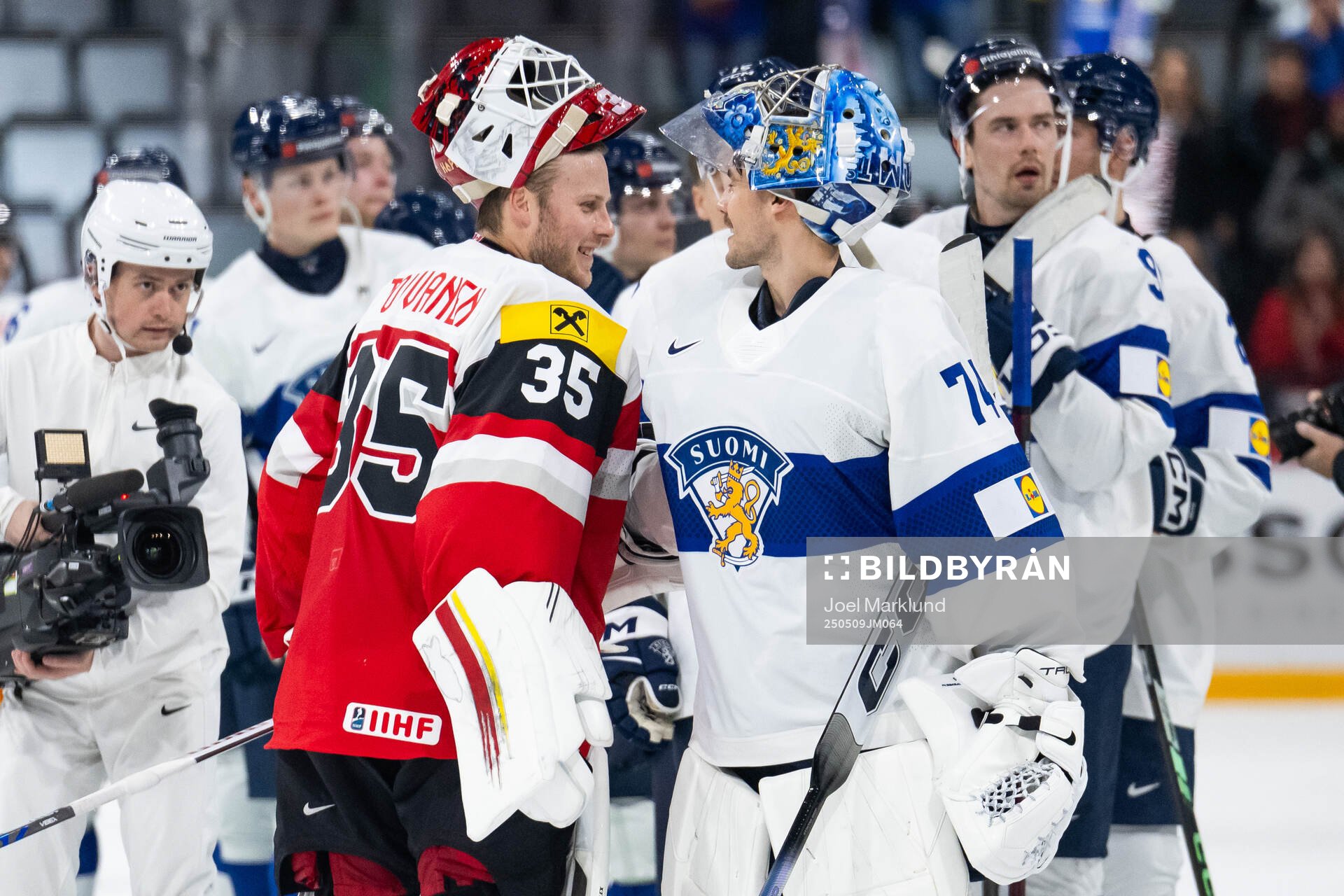 Goaltender Atte Tolvanen of Austria with goaltender Juuse