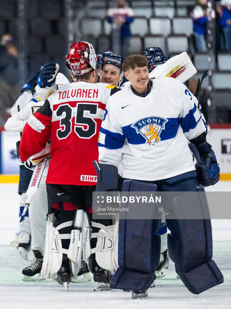 Goaltender Atte Tolvanen of Austria with Eeli Tolvanen of