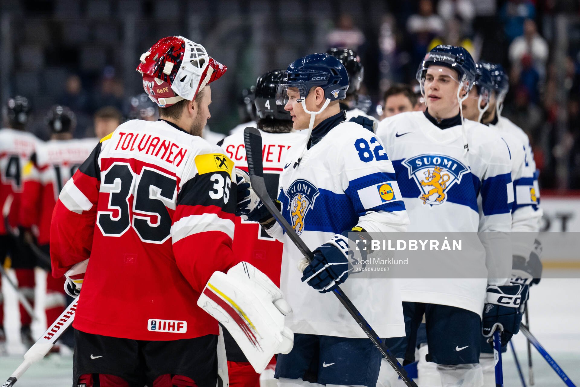 Goaltender Atte Tolvanen of Austria with Harri Pesonen of