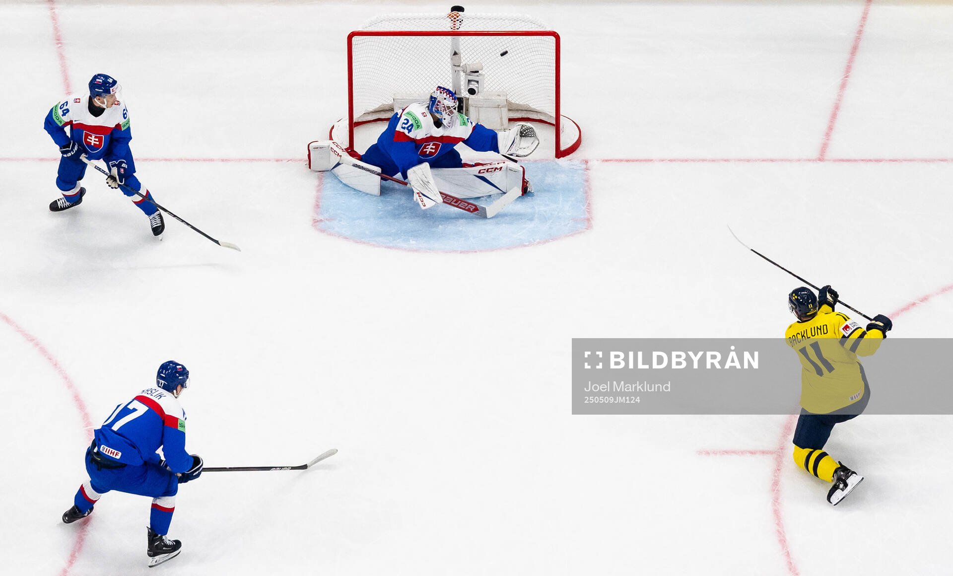 Mikael Backlund of Sweden scores 1-0 behind goaltender