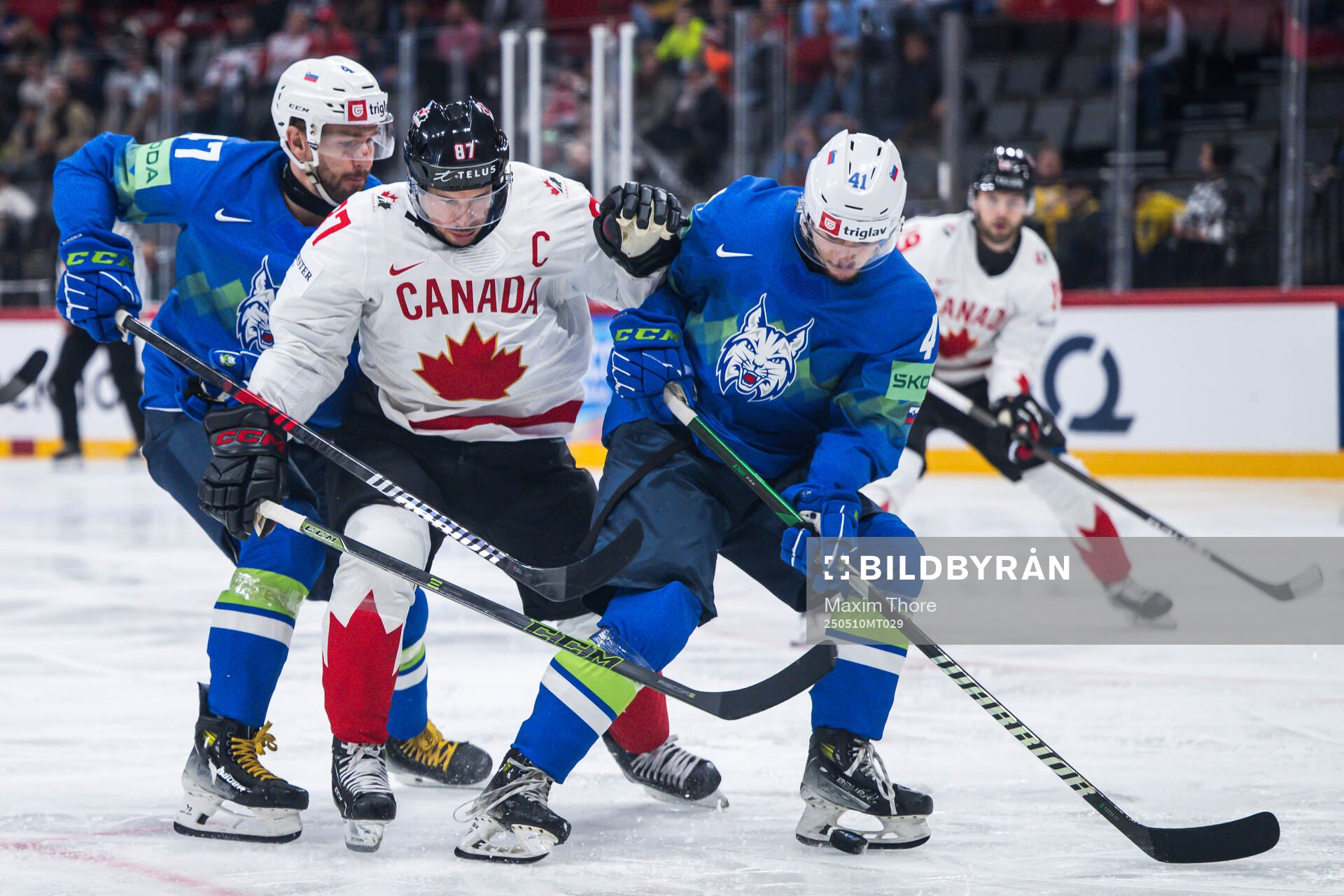 Rok Macuh and Jan Cosic of Slovenia and Sidney Crosby of
