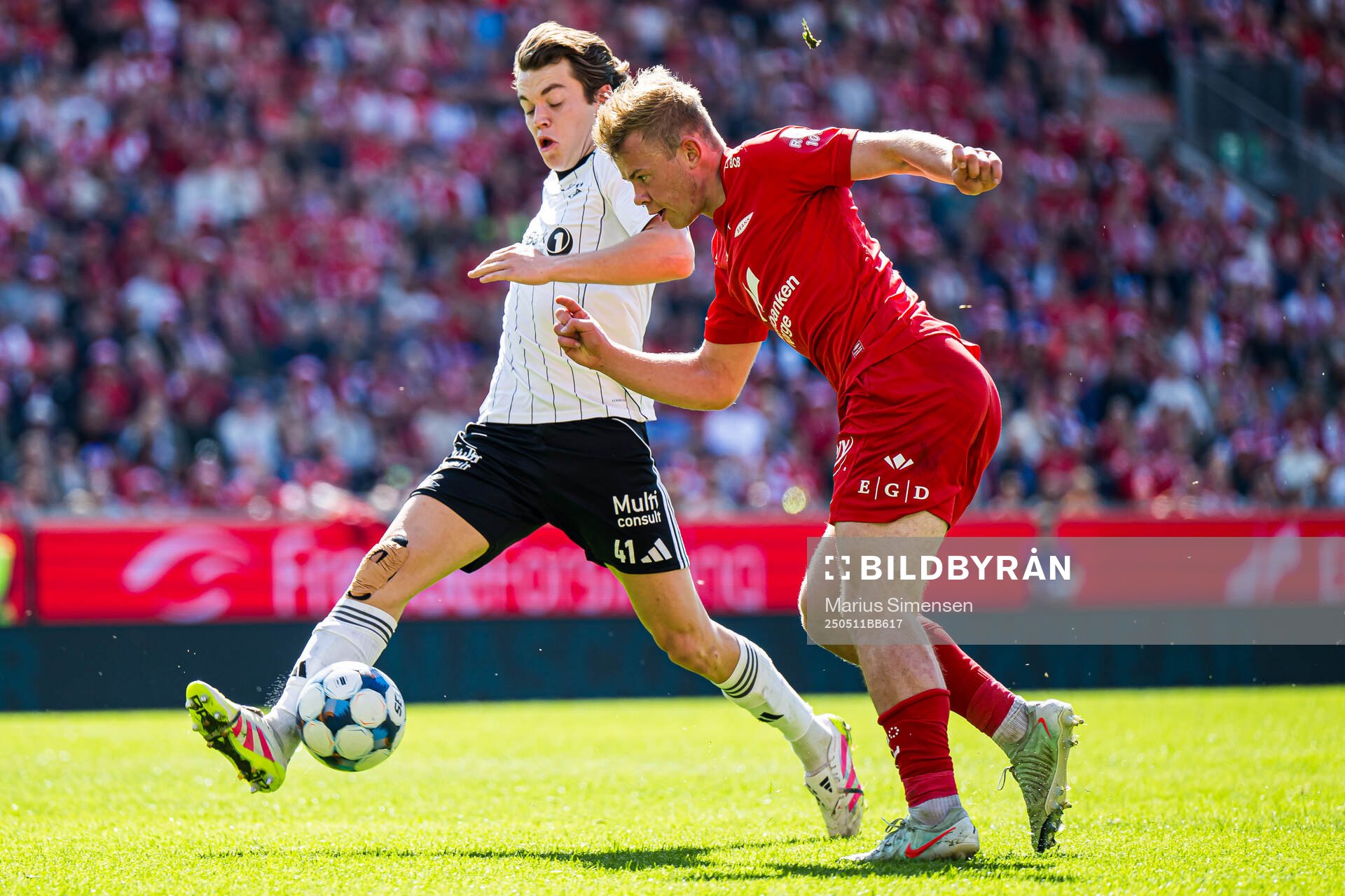 Sverre Halseth Nypan of Rosenborg and Aune Heggebø of Brann during the Eliteserien match between Brann and Rosenborg on May 11, 2025 in Bergen.