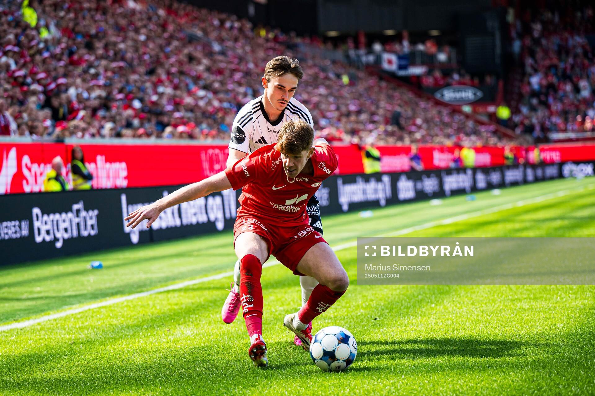 Marius Sivertsen Broholm of Rosenborg and Thore Pedersen of Brann during the Eliteserien match between Brann and Rosenborg on May 11, 2025 in Bergen.
