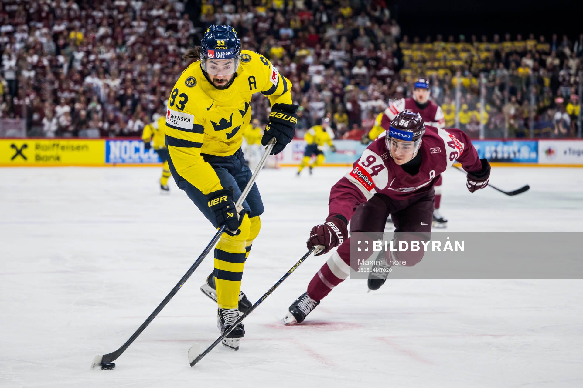 Mika Zibanejad of Sweden and Kristians Rubins of Latvia