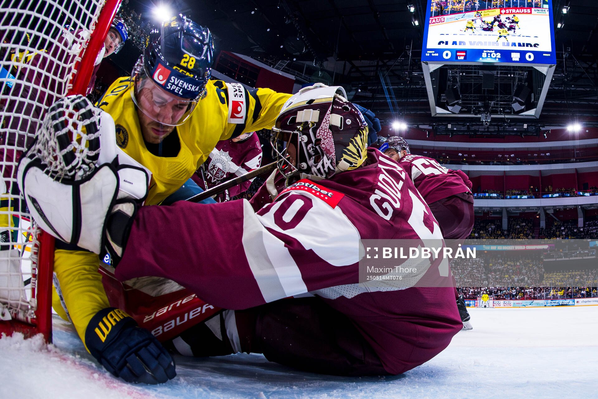 Elias Lindholm of Sweden and goaltender Kristers Gudlevskis