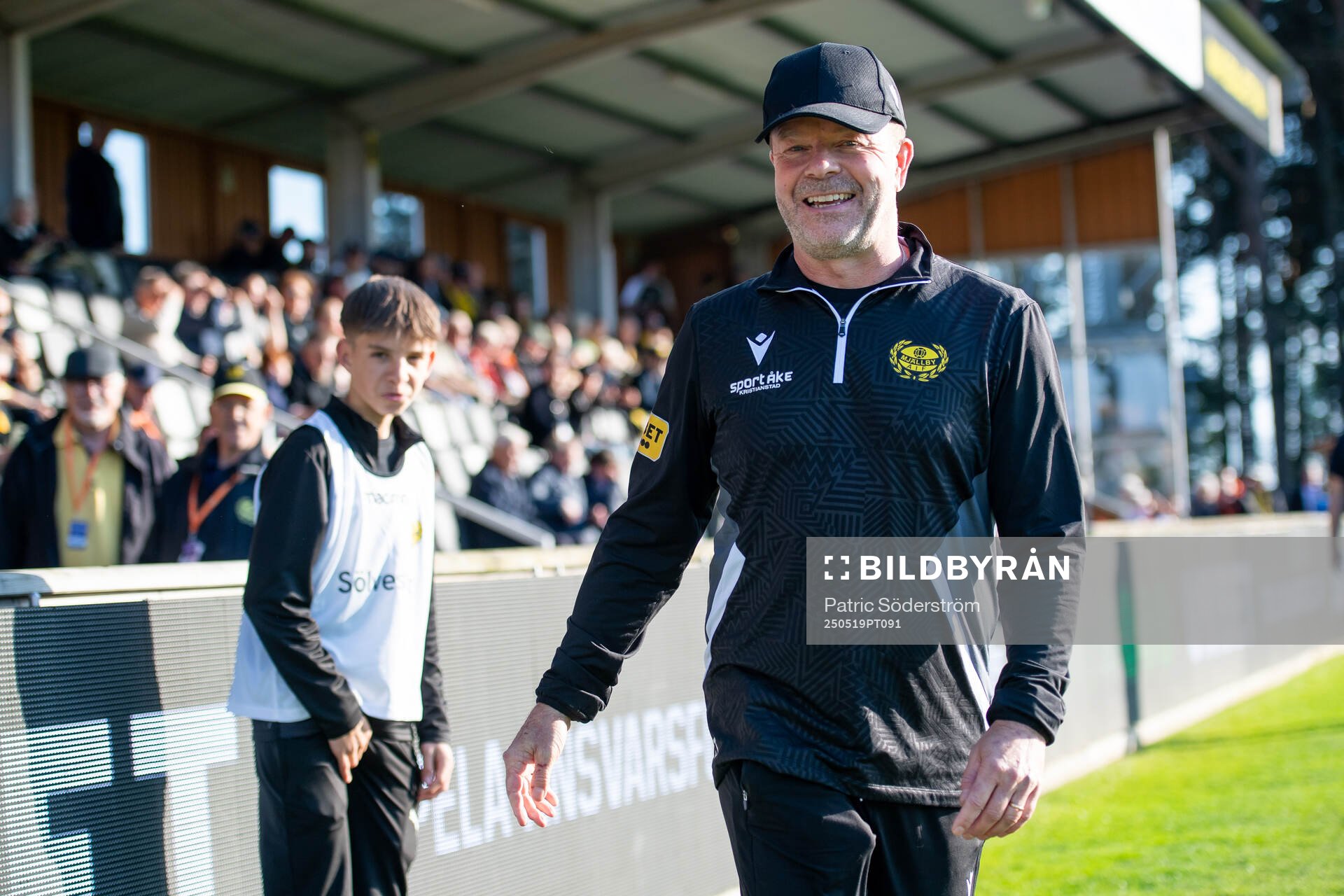 Mjällbys tränare Anders Torstensson med sitt barnbarn Mio Eriksson under fotbollsmatchen i Allsvenskan mellan Mjällby och Brommapojkarna den 19 maj 2025 i Hällevik.