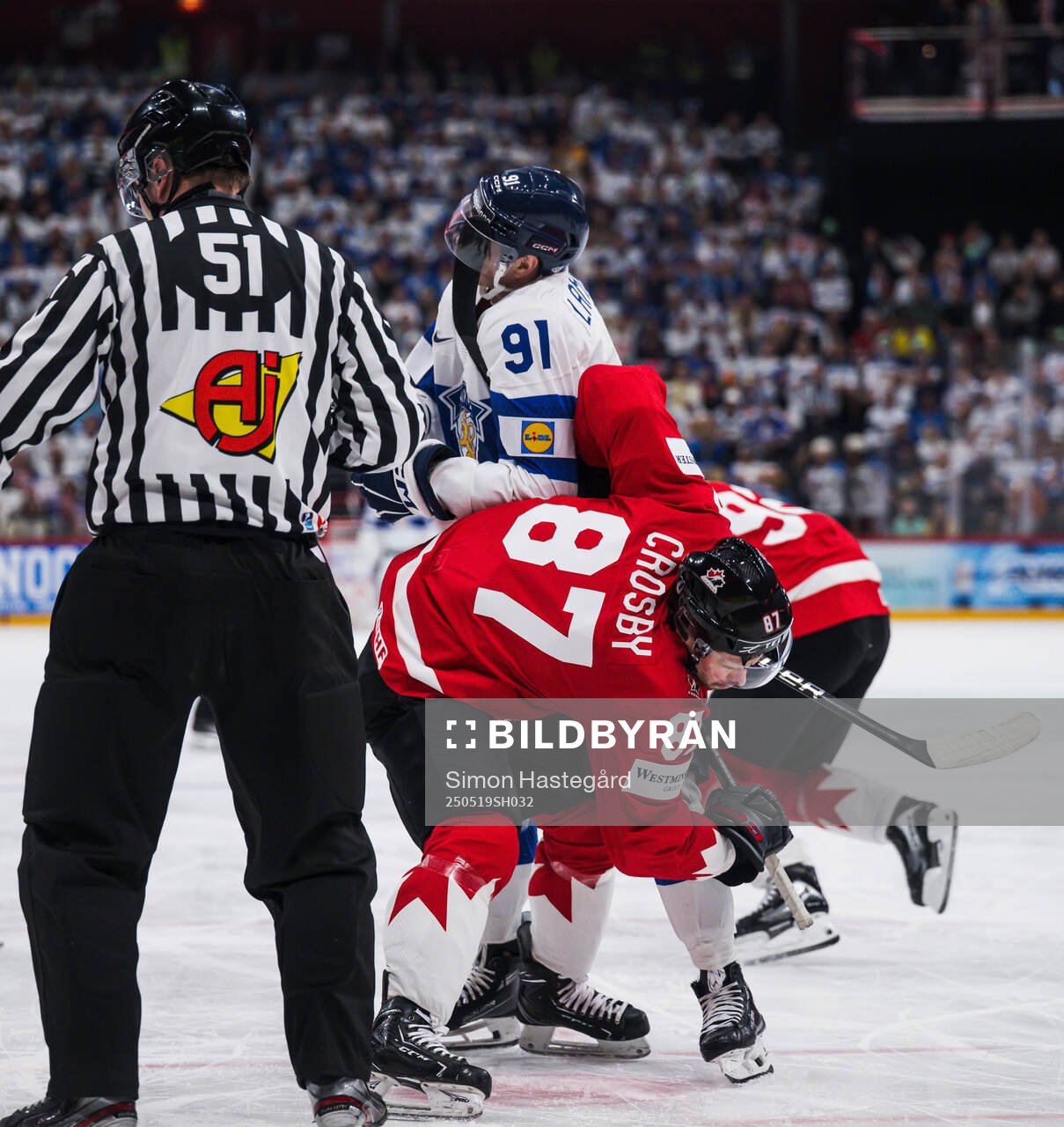 Juho Lammikko of Finland and Sidney Crosby of Canada
