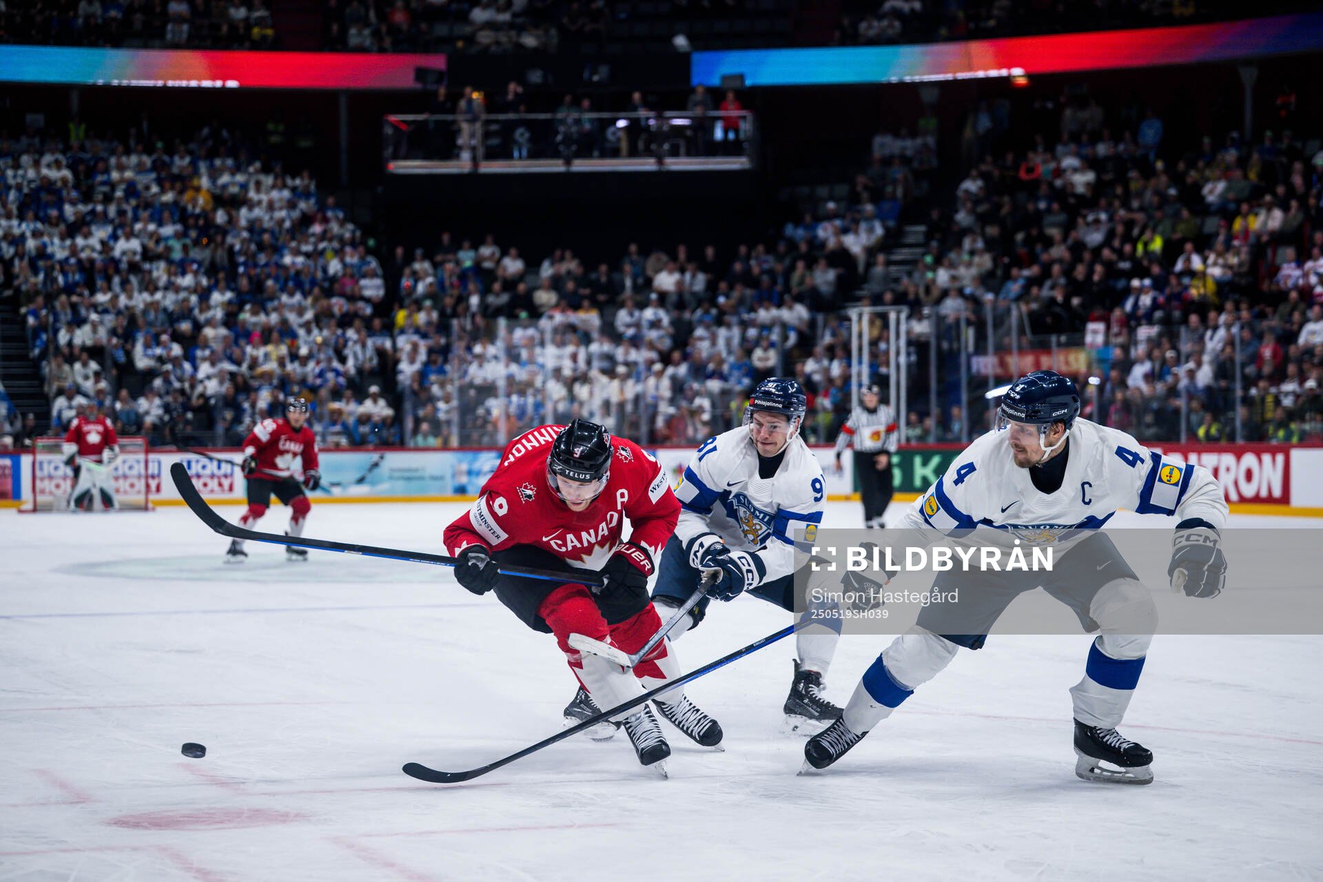 Nathan MacKinnon of Canada and Juho Lammikko and Mikko
