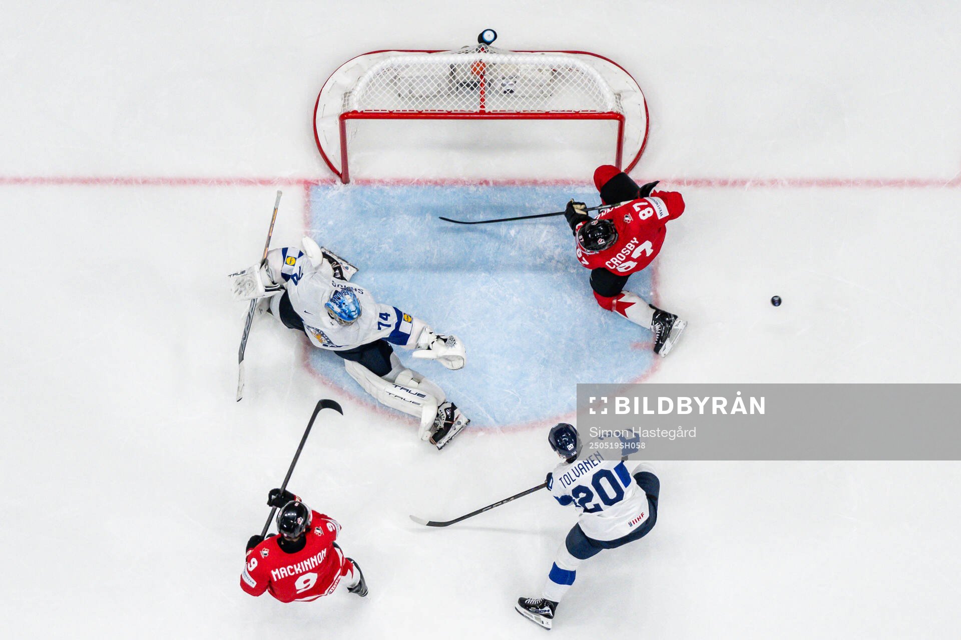 Sidney Crosby and Nathan MacKinnon of Canada against Eeli