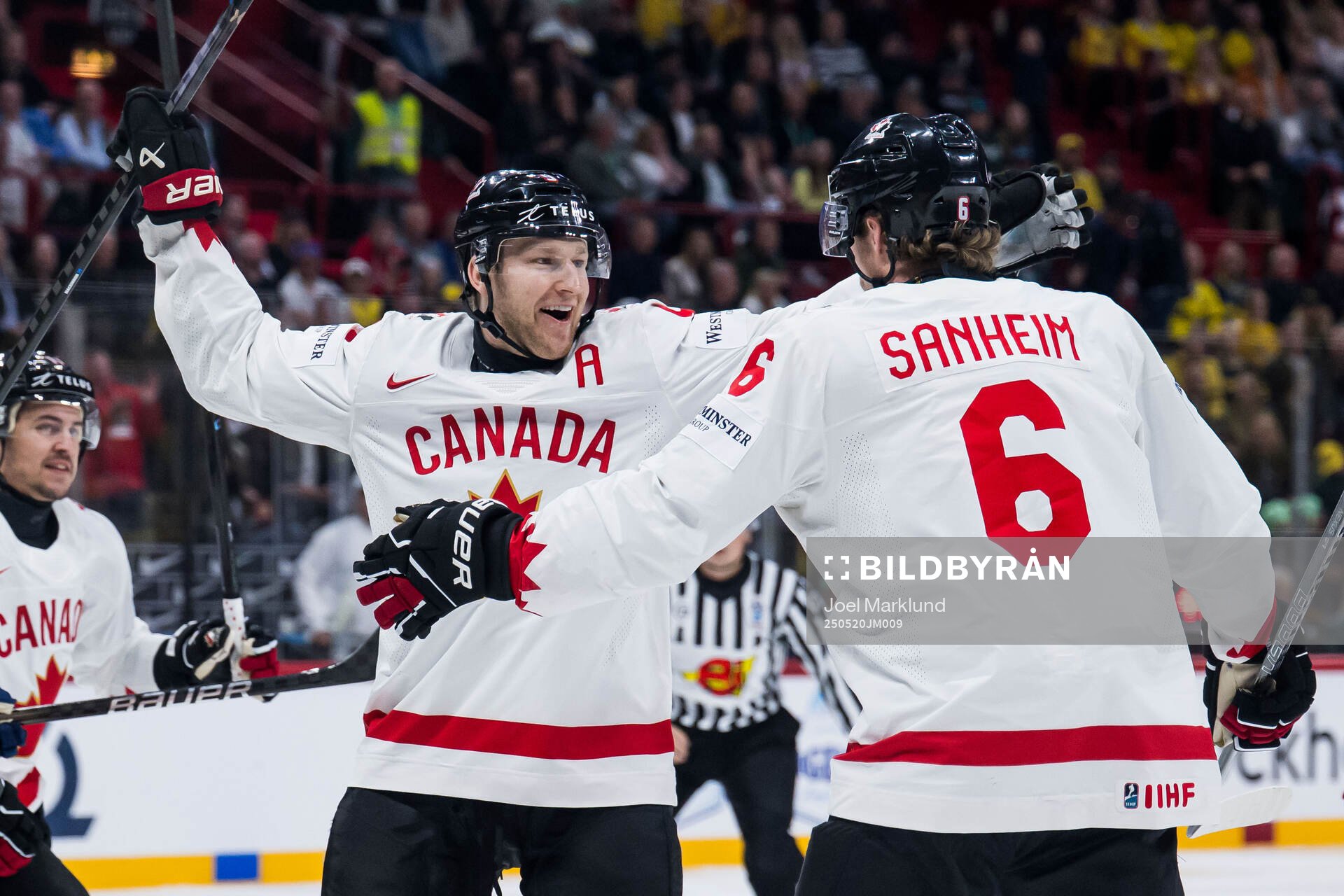 Nathan MacKinnon and Travis Sanheim of Canada celebrate