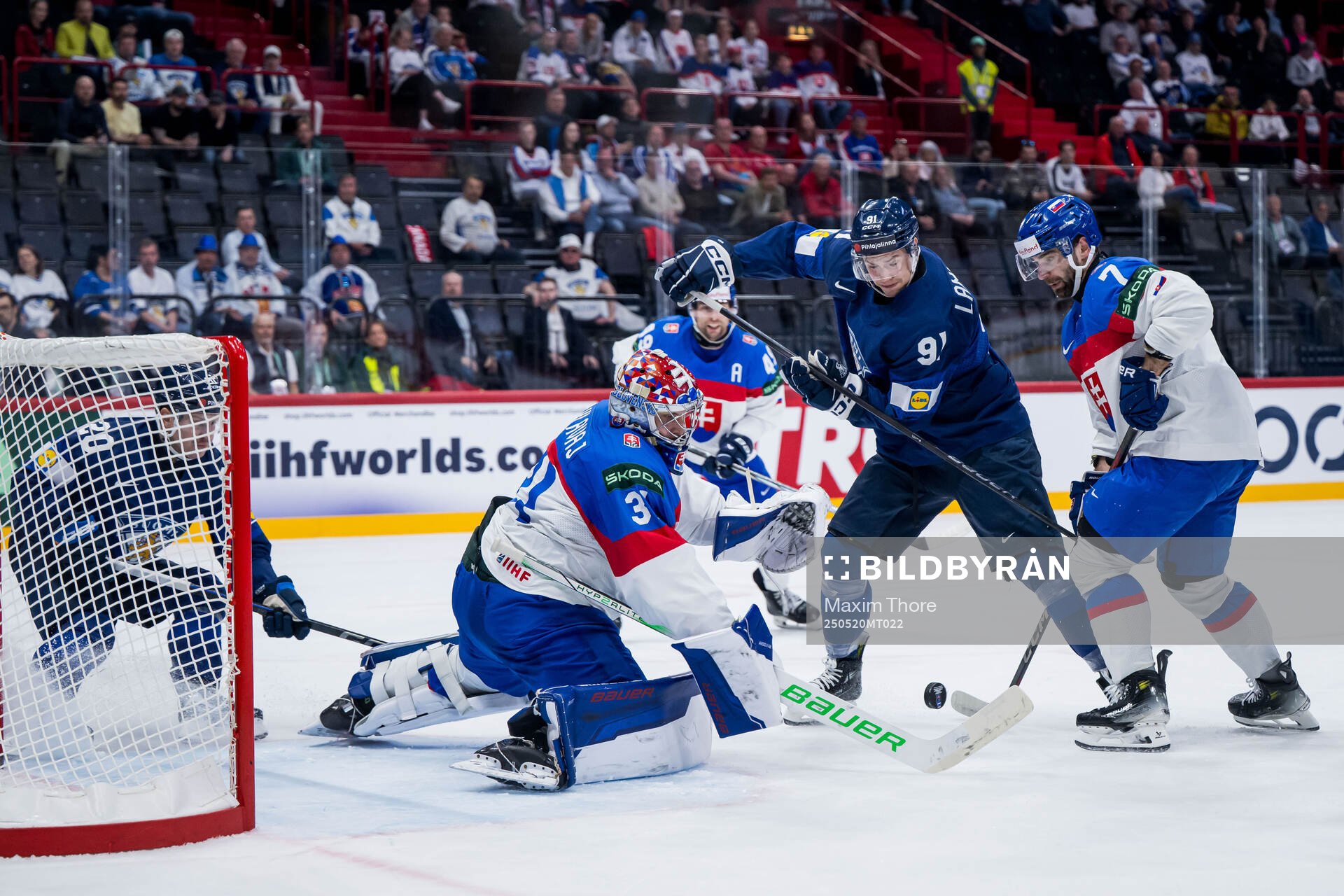 Juho Lammikko of Finland and goaltender Samuel Hlavaj of