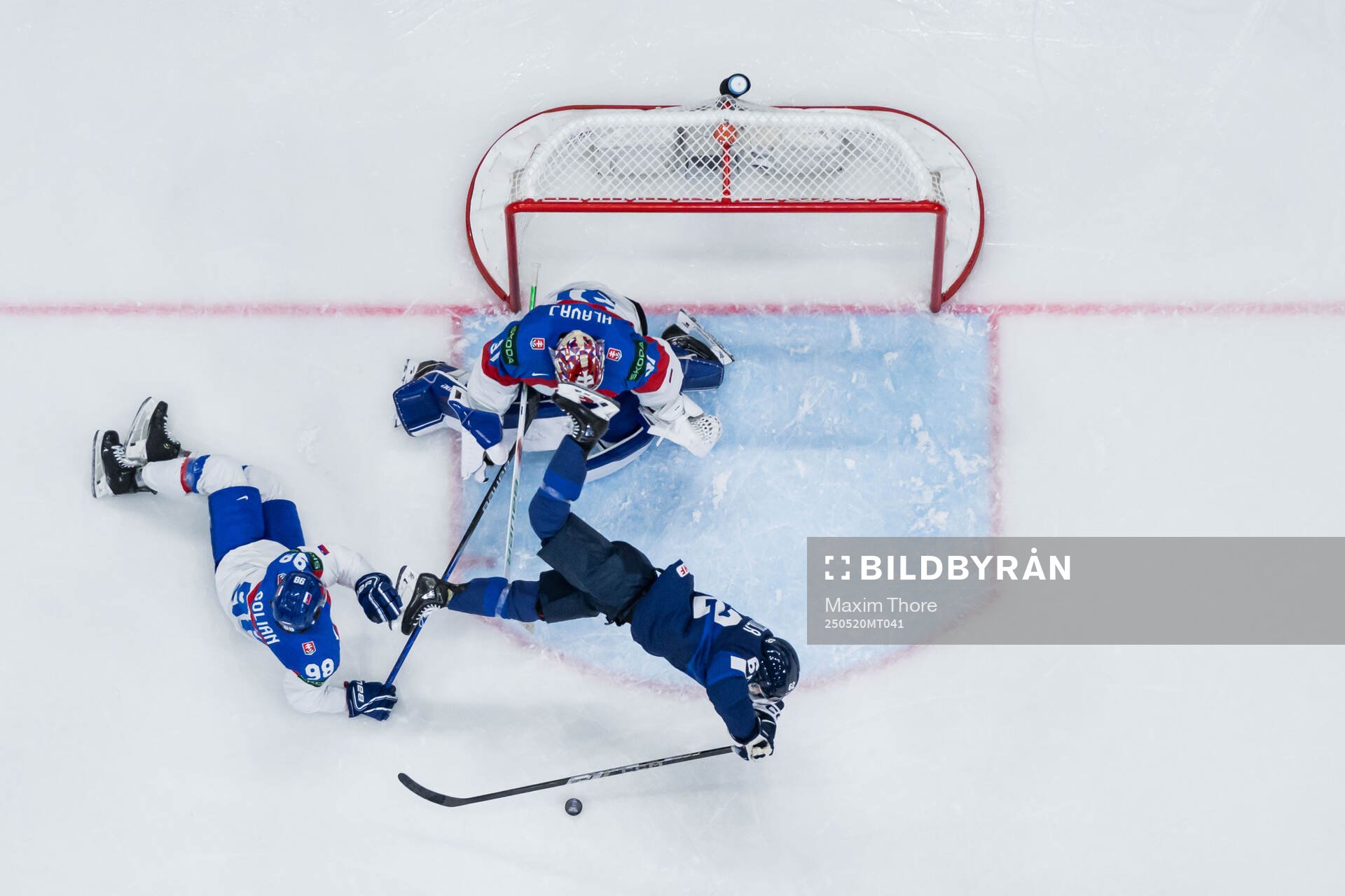 Andrej Golian and goaltender Samuel Hlavaj of Slovakia and