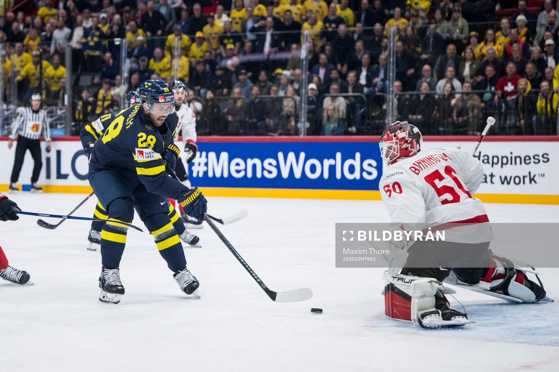 Elias Lindholm of Sweden scores 1-1 behind goaltender