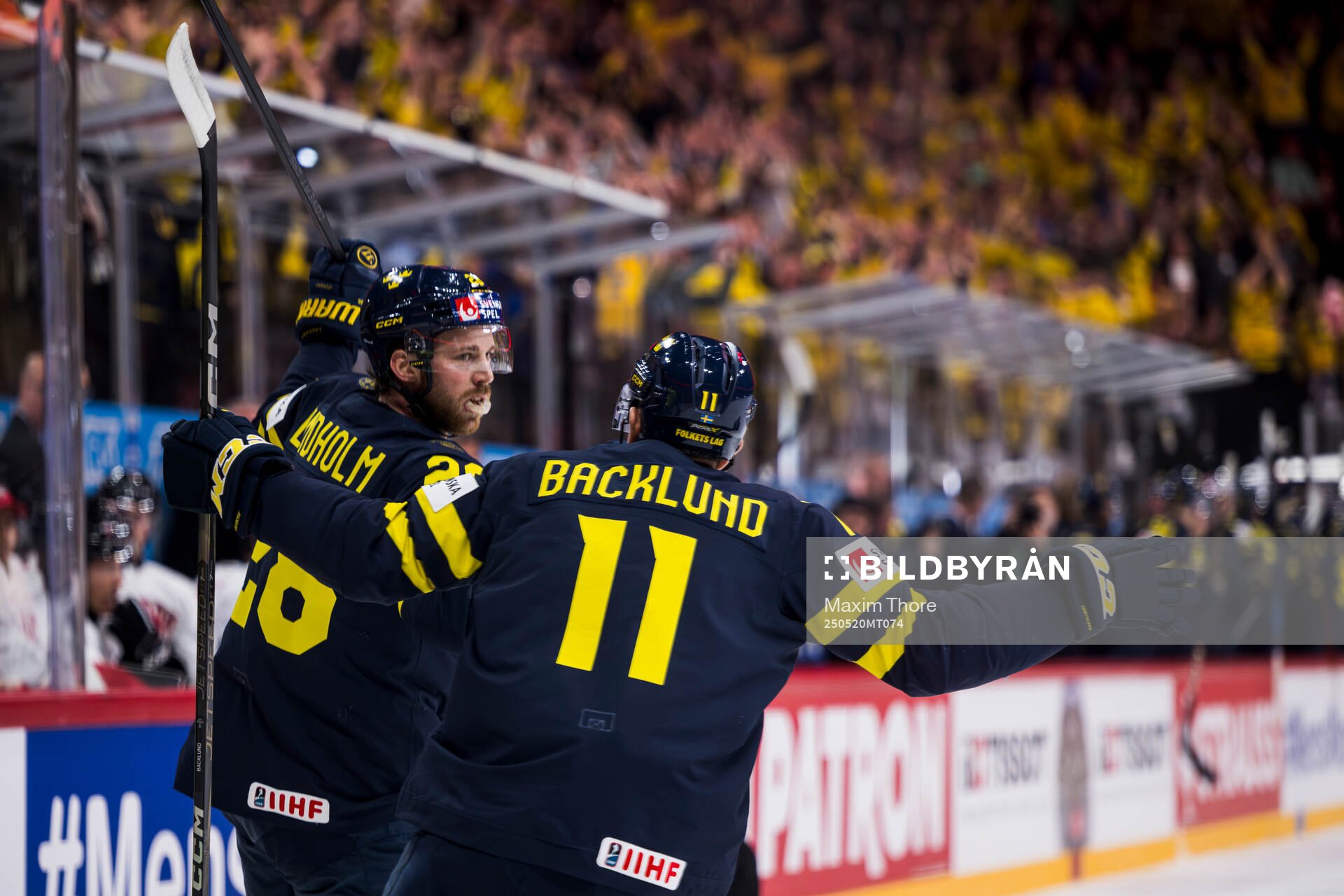 Elias Lindholm and Mikael Backlund of Sweden celebrate the