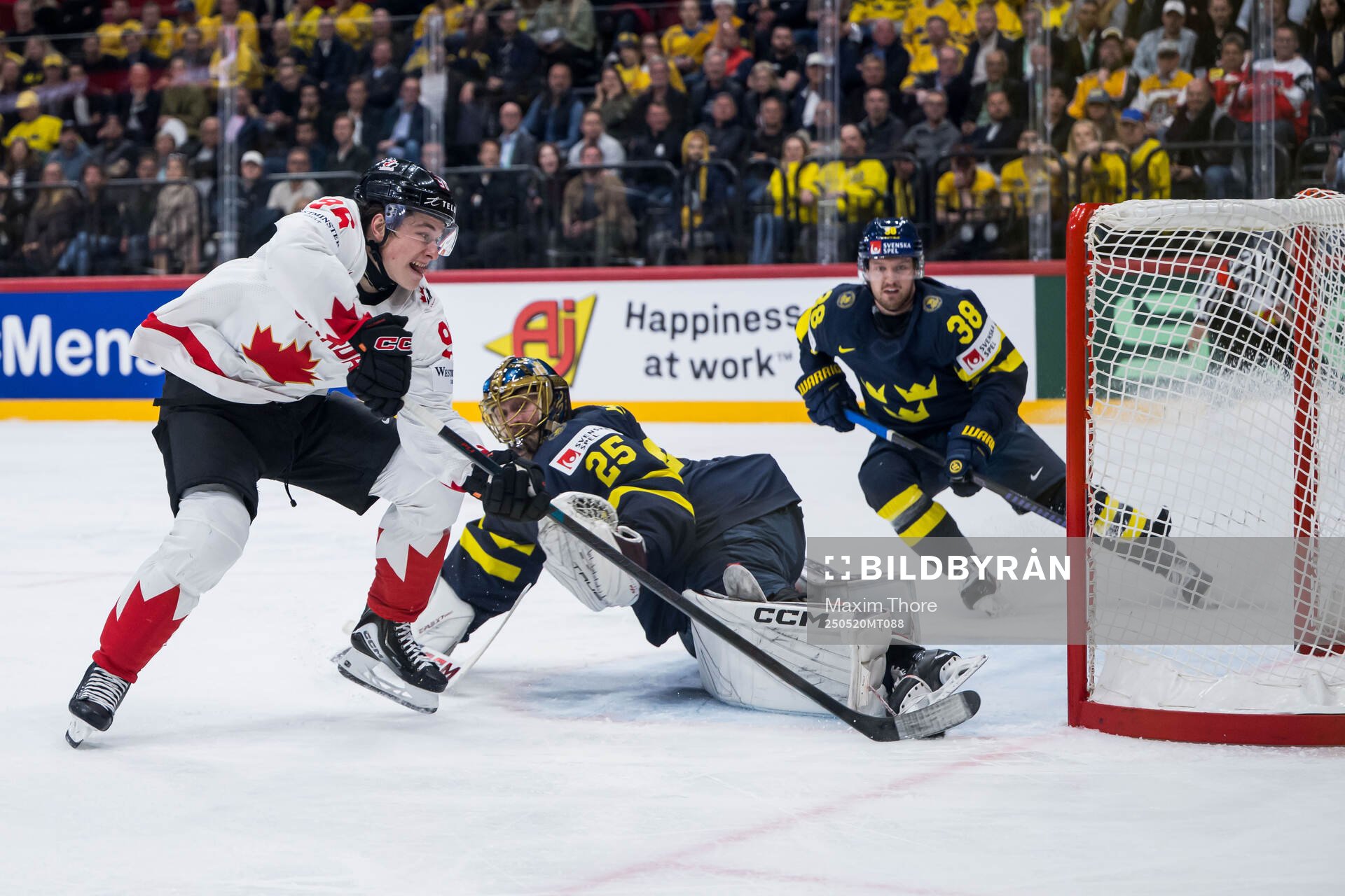 Macklin Celebrini of Canada scores 2-4 behind goaltender