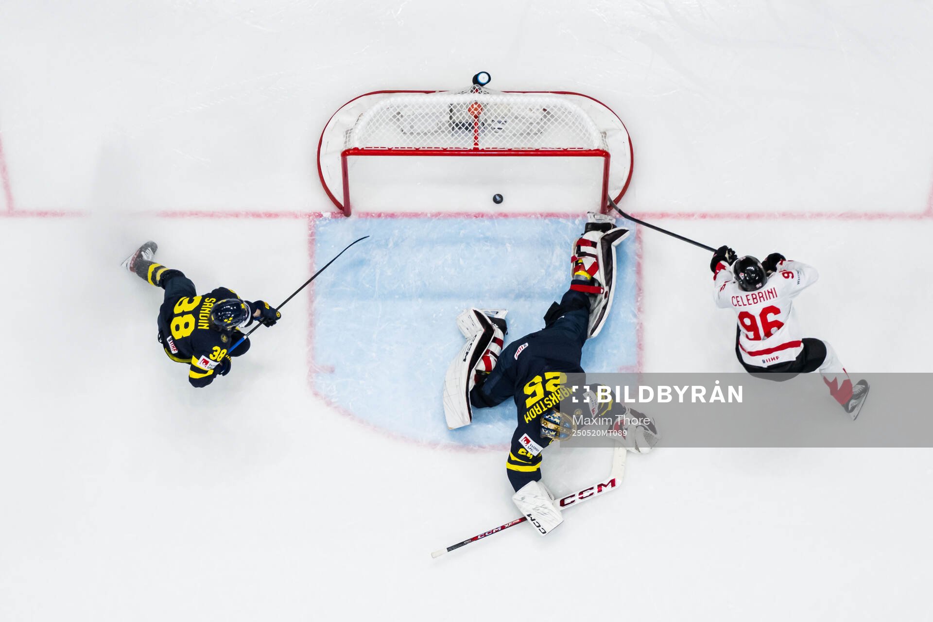 Macklin Celebrini of Canada scores 2-4 behind goaltender
