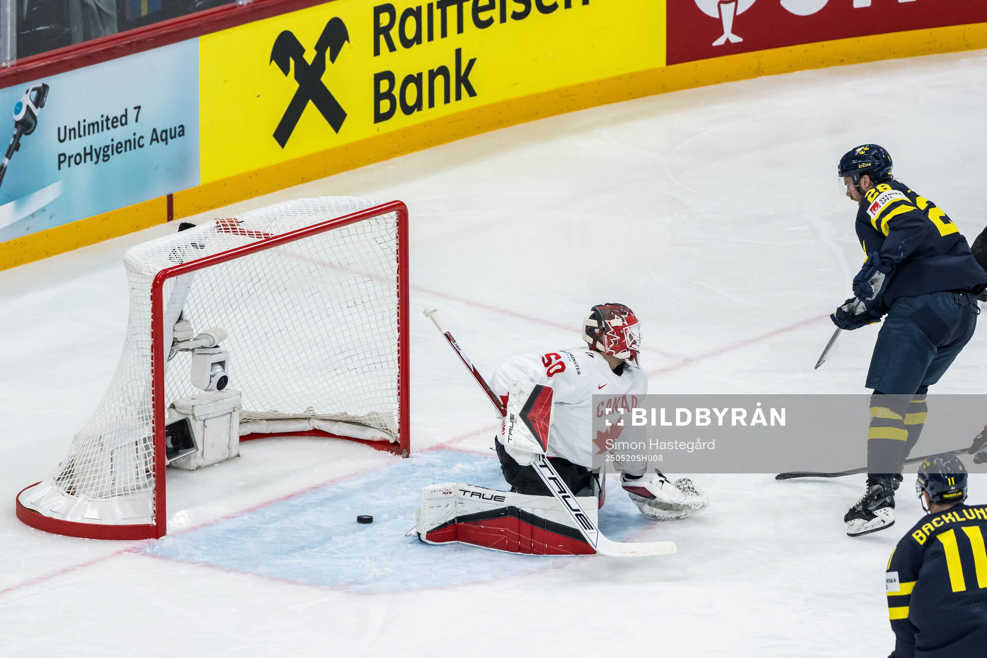 Elias Lindholm of Sweden scores 1-1 behind goaltender