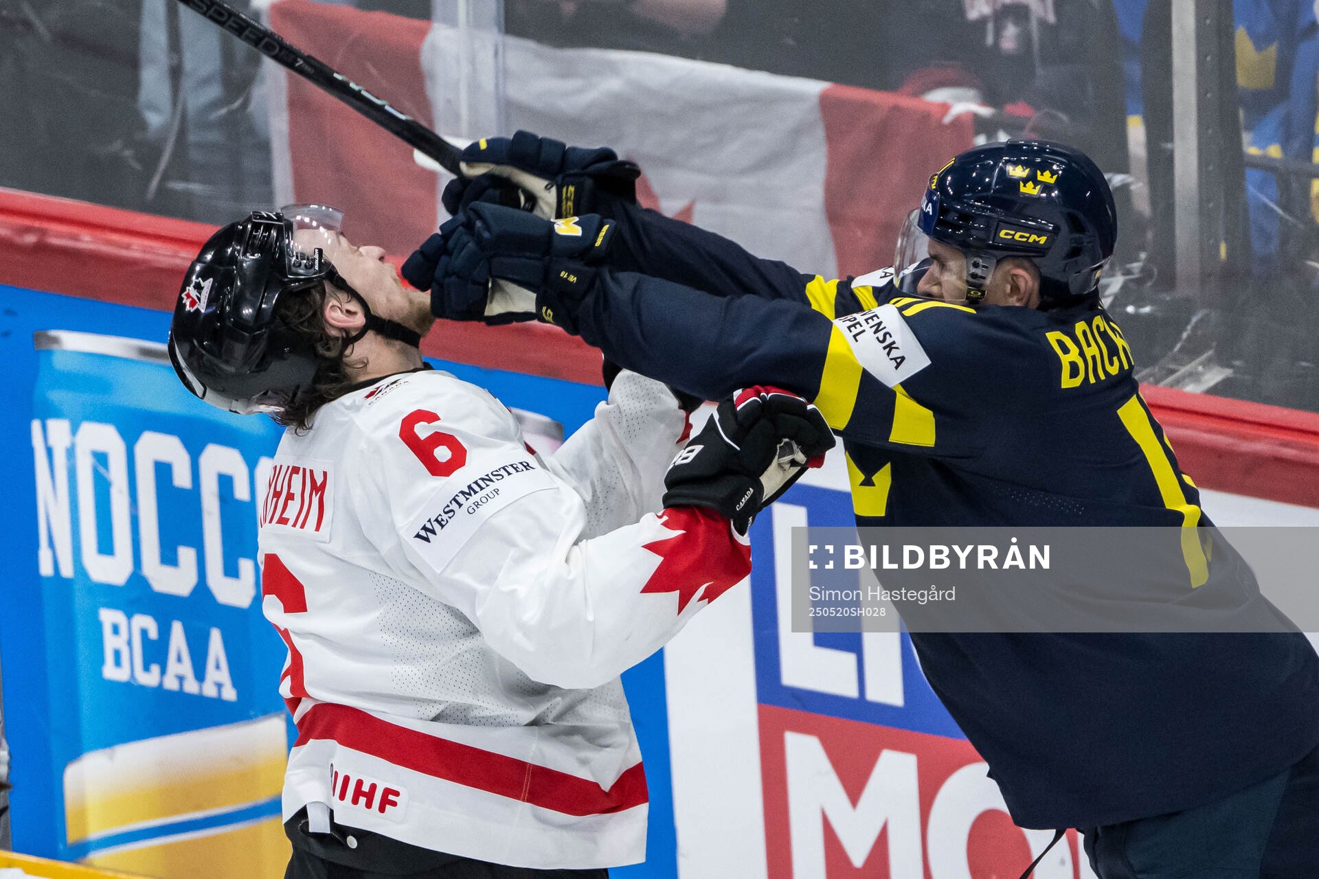 Travis Sanheim of Canada and Mikael Backlund of Sweden