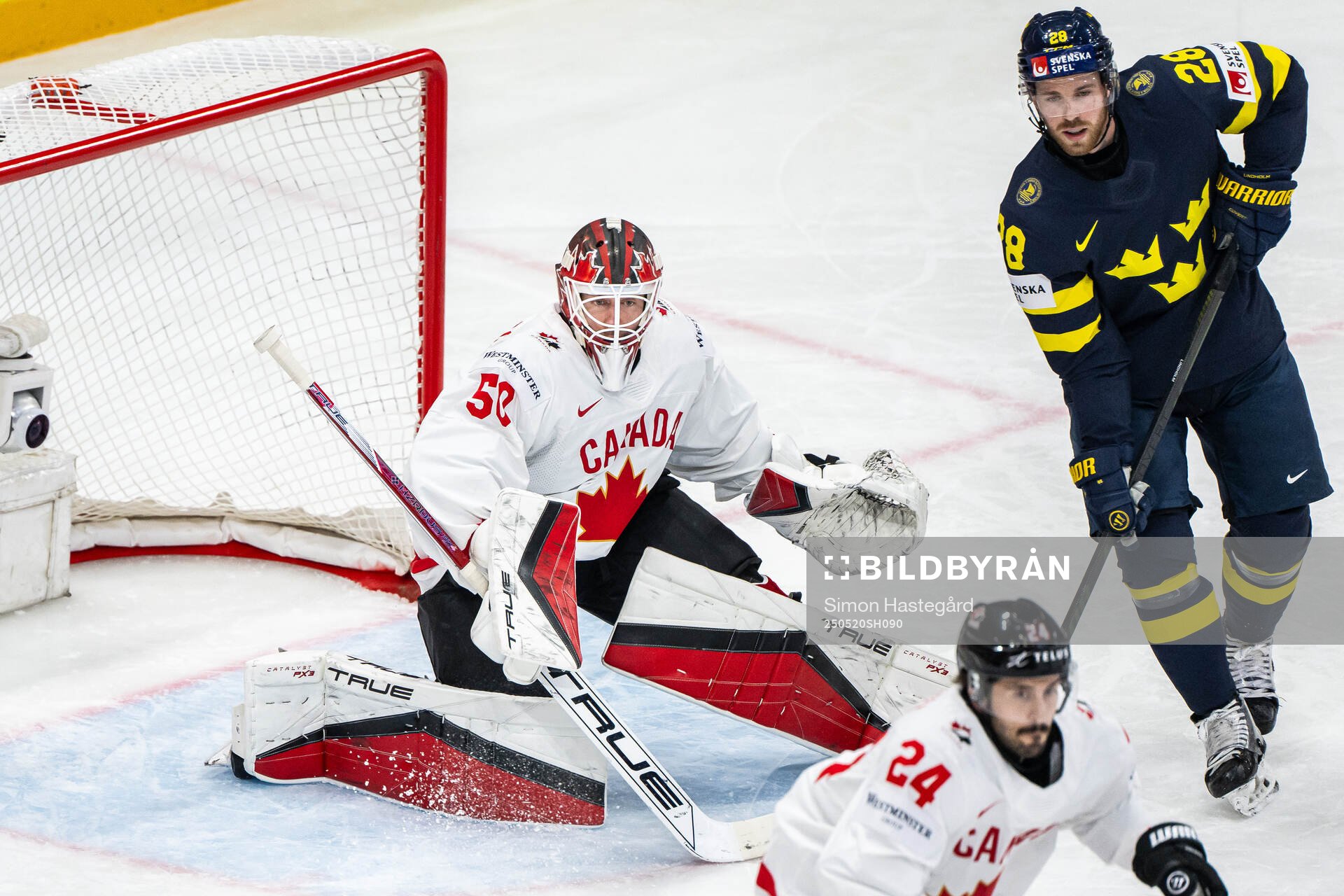 Goaltender Jordan Binnington of Canada and Elias Lindholm